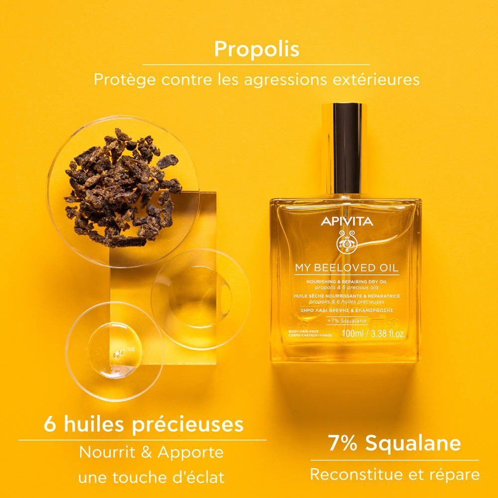 Flacon d'Apivita My Beeloved Oil à côté de grains de propolis et six huiles précieuses.