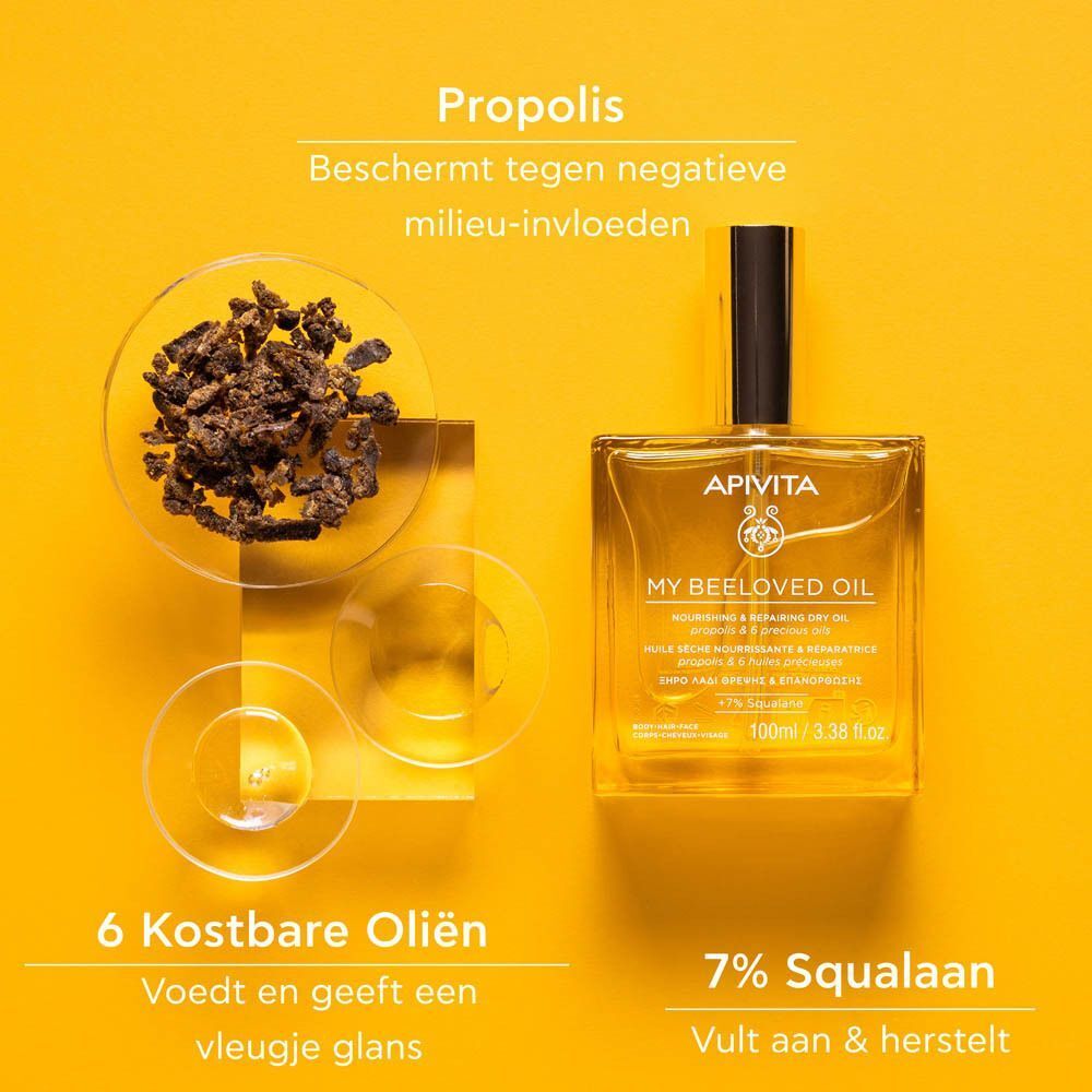 Fles Apivita My Beeloved Oil naast propoliskorrels en zes kostbare oliën.