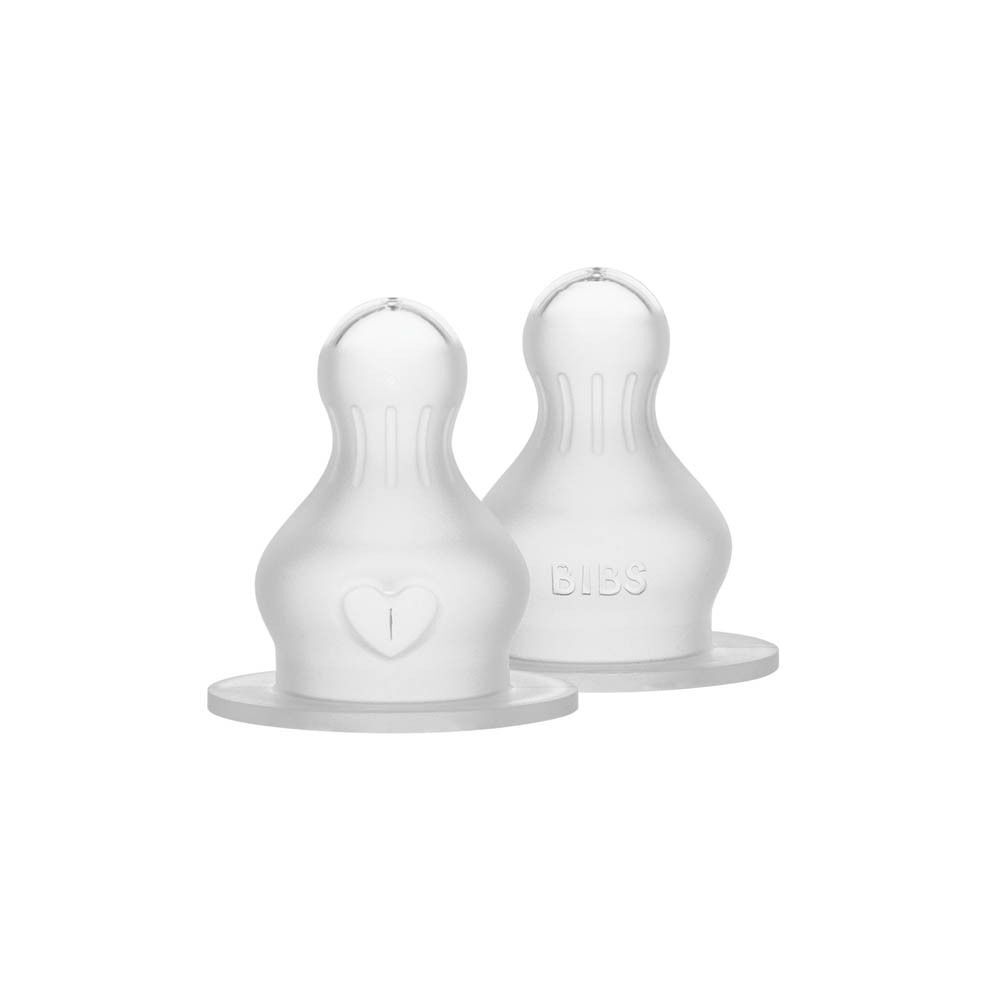 Deux tétines BIBS en silicone de qualité médicale, représentées individuellement. Une avec un symbole de cœur.