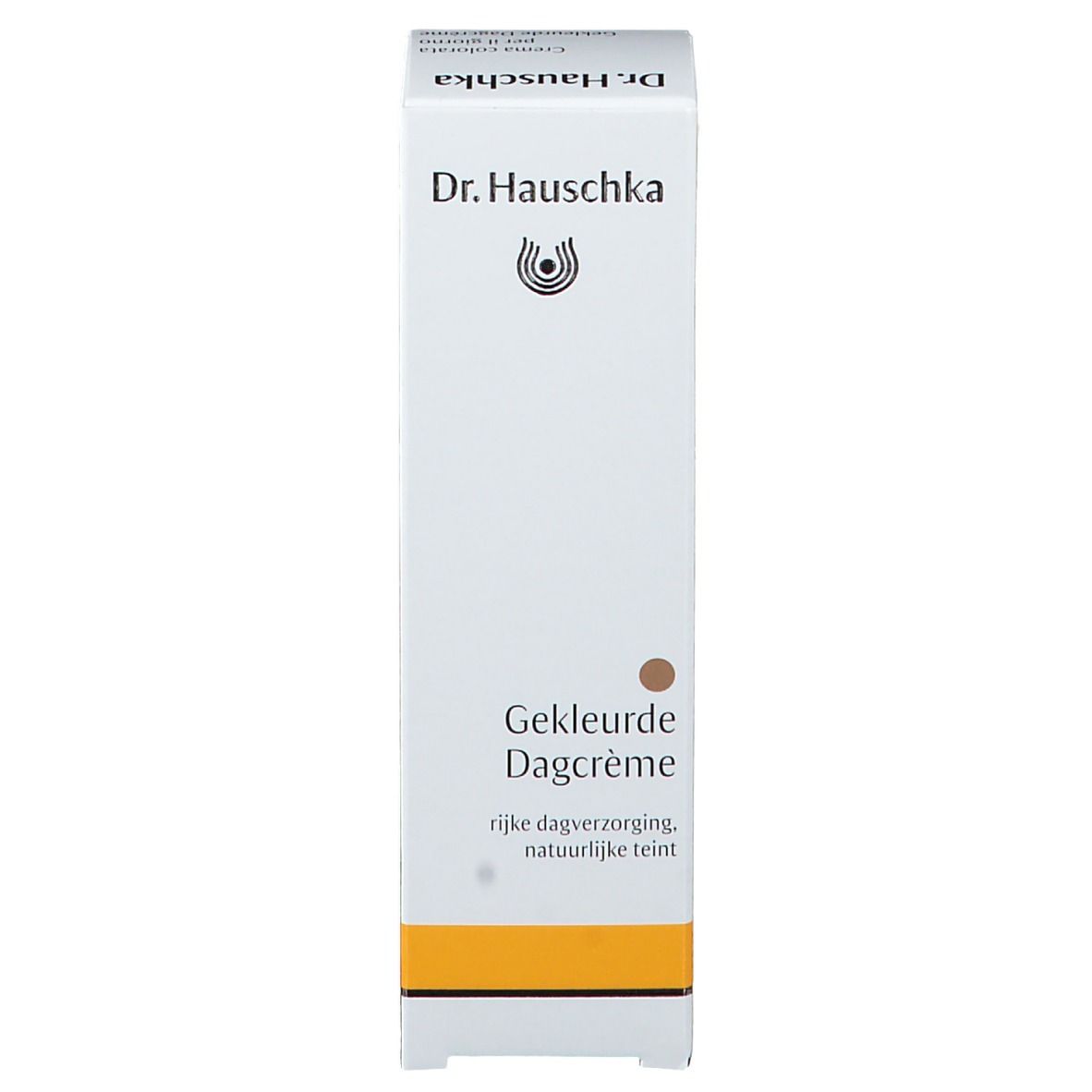 Schachtel. Text: Gekleurde Dagcrème. Marke: Dr. Hauschka. Gelber Streifen.