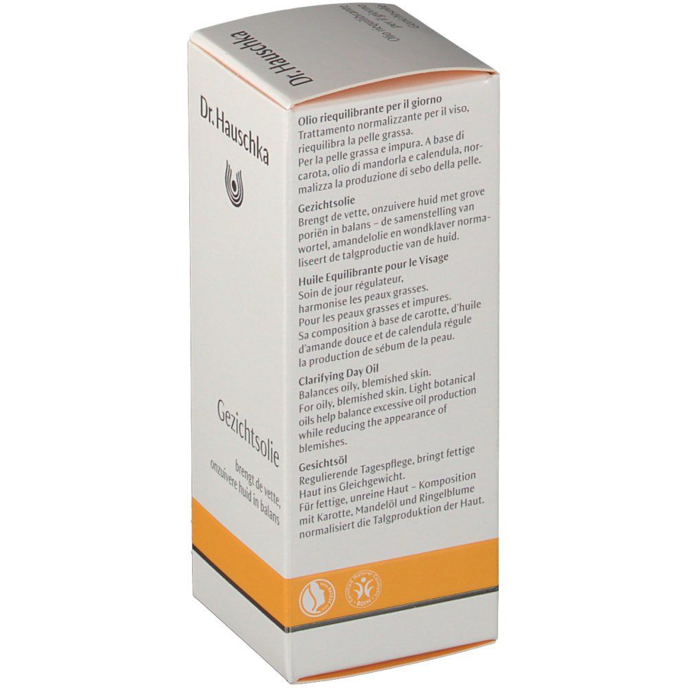 Emballage en carton avec logo et texte multilingue. Accent orange en bas. Soin pour le visage.