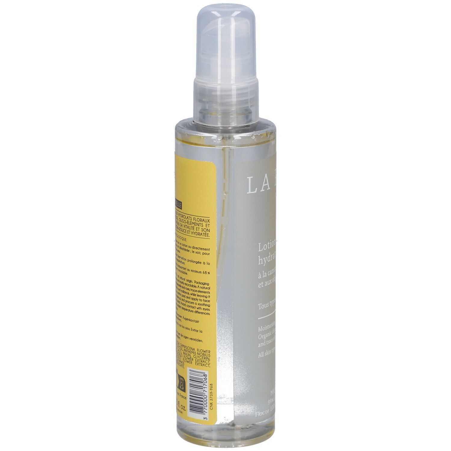 Flacon de lotion tonique avec vaporisateur. Dos avec étiquette jaune et texte. LA ROSÉE PARIS. Liquide transparent.