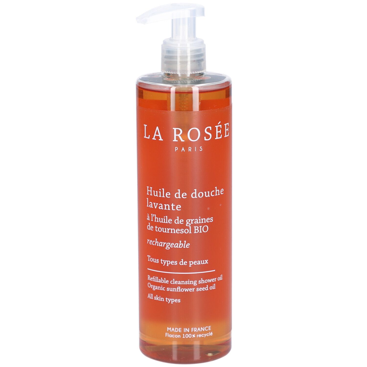 Flacon transparent avec liquide orangé et pompe doseuse. Inscription: La Rosée, Huile de douche lavante.