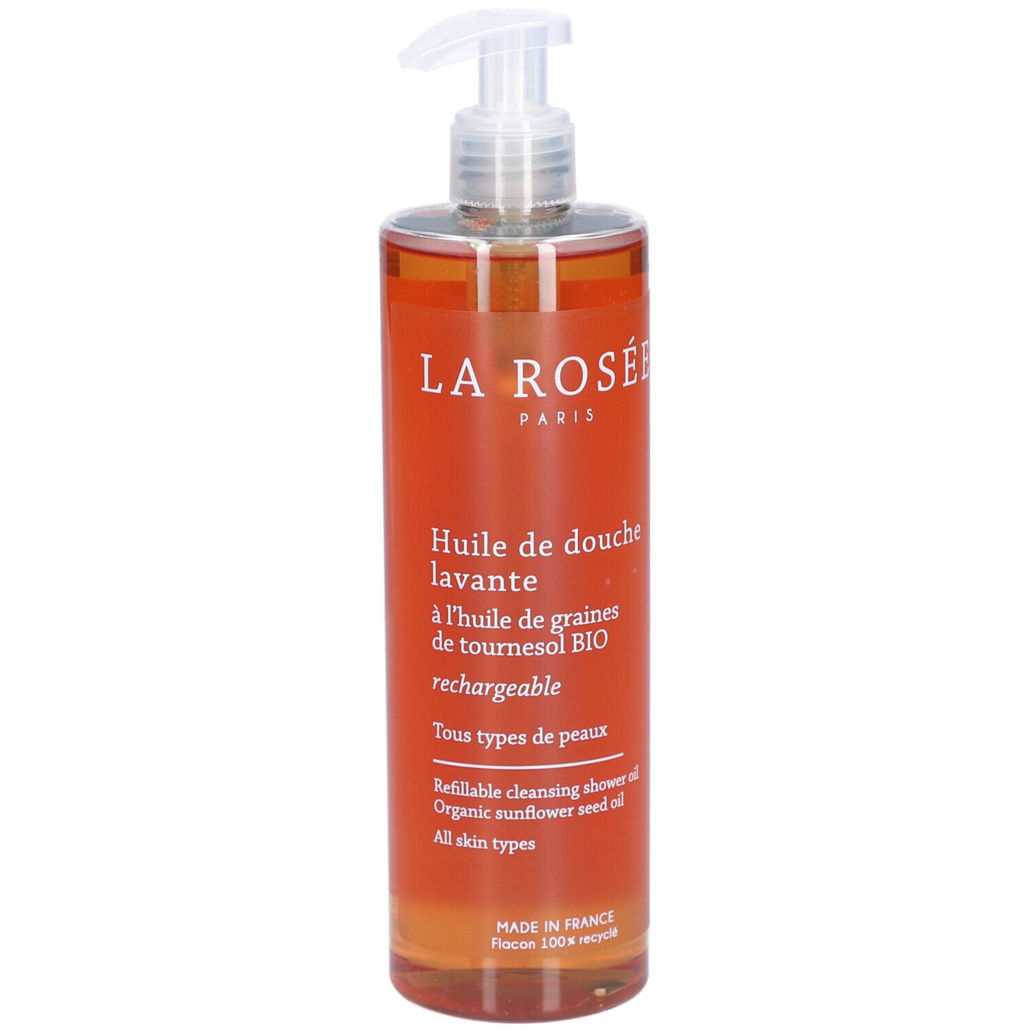 Flacon transparent avec liquide orangé et pompe doseuse. Inscription: La Rosée, Huile de douche lavante.
