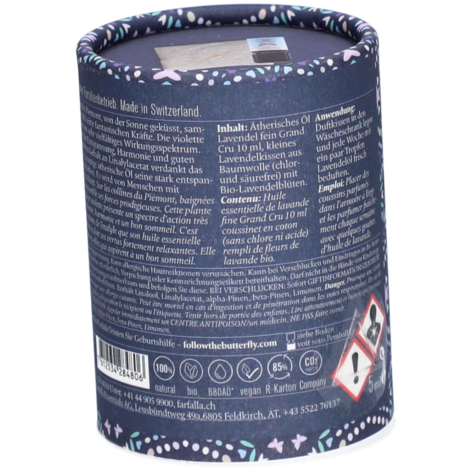Emballage cylindrique à motifs floraux. Texte : ingrédients, instructions d'utilisation, informations fabricant, certifications.