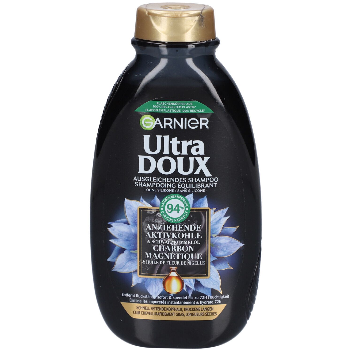 Flacon noir de shampooing, bouchon doré. Texte: GARNIER Ultra DOUX, Shampooing équilibrant, Charbon magnétique & huile de fleur de nigelle. 94% d'ingrédients naturels.
