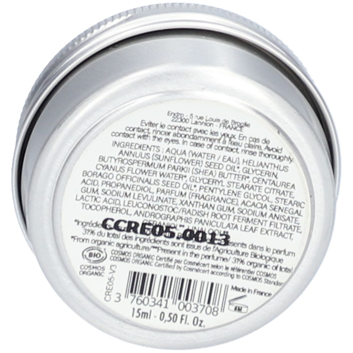Boîte ronde argentée avec informations produit. Ingrédients et certifications sont visibles.