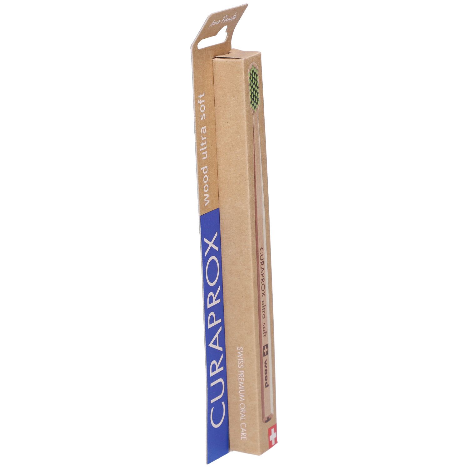 Verpackung einer Zahnbürste. Holzgriff sichtbar. Marke CURAPROX, Schriftzug 'wood ultra soft'. Schweizer Kreuz.