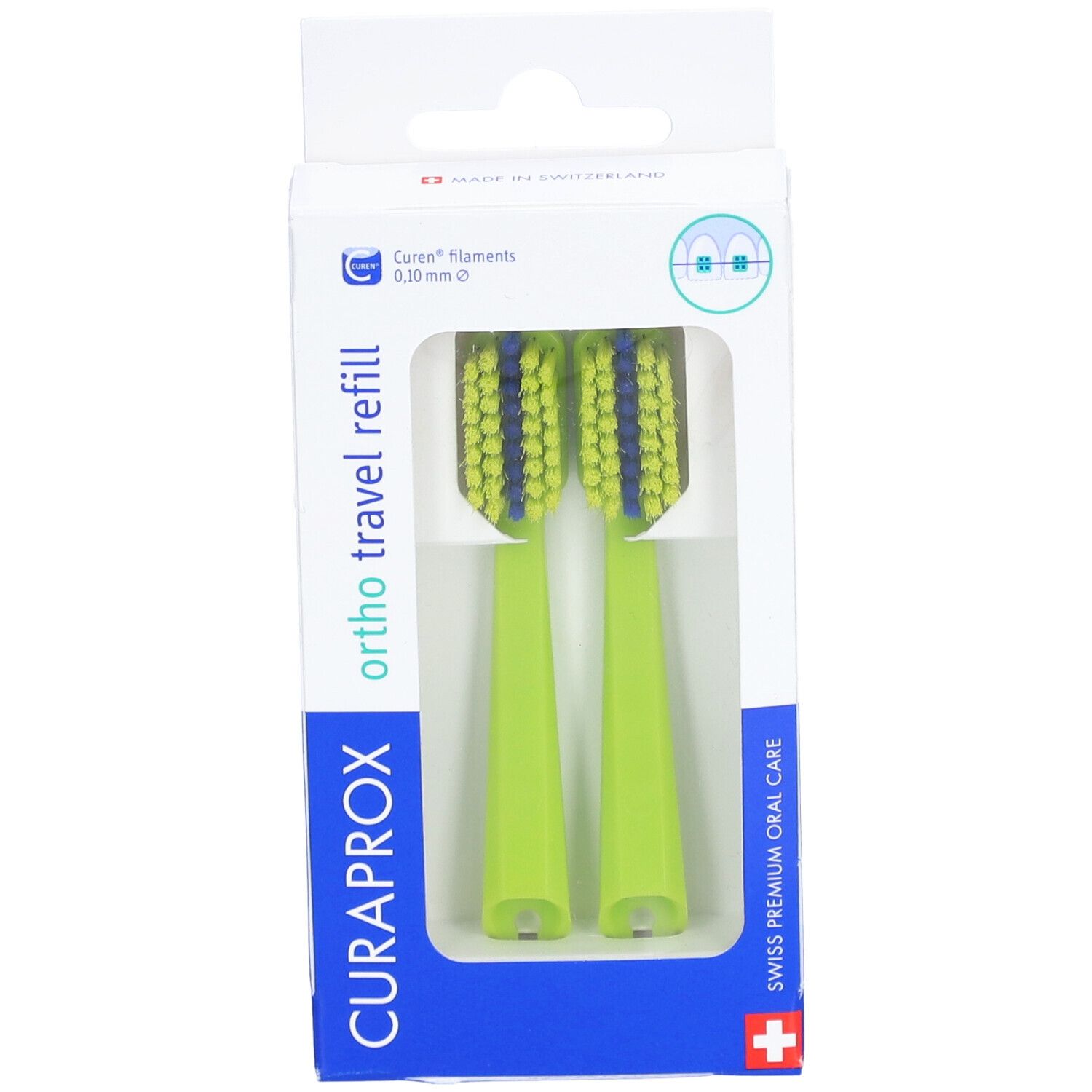 Deux têtes de brosse à dents vertes dans un emballage. Soies bleues. "CURAPROX" et "ortho travel refill" visibles.