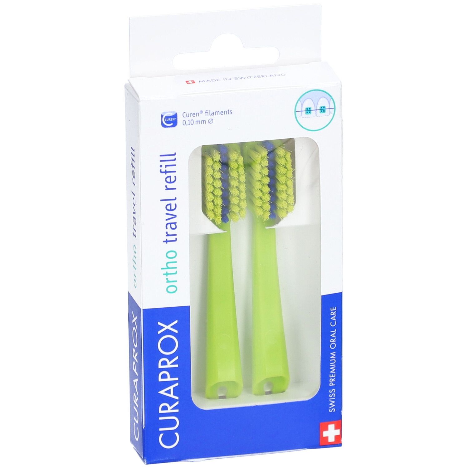 Deux têtes de brosse à dents vertes dans un emballage. Soies bleues. "CURAPROX" et "ortho travel refill" visibles.