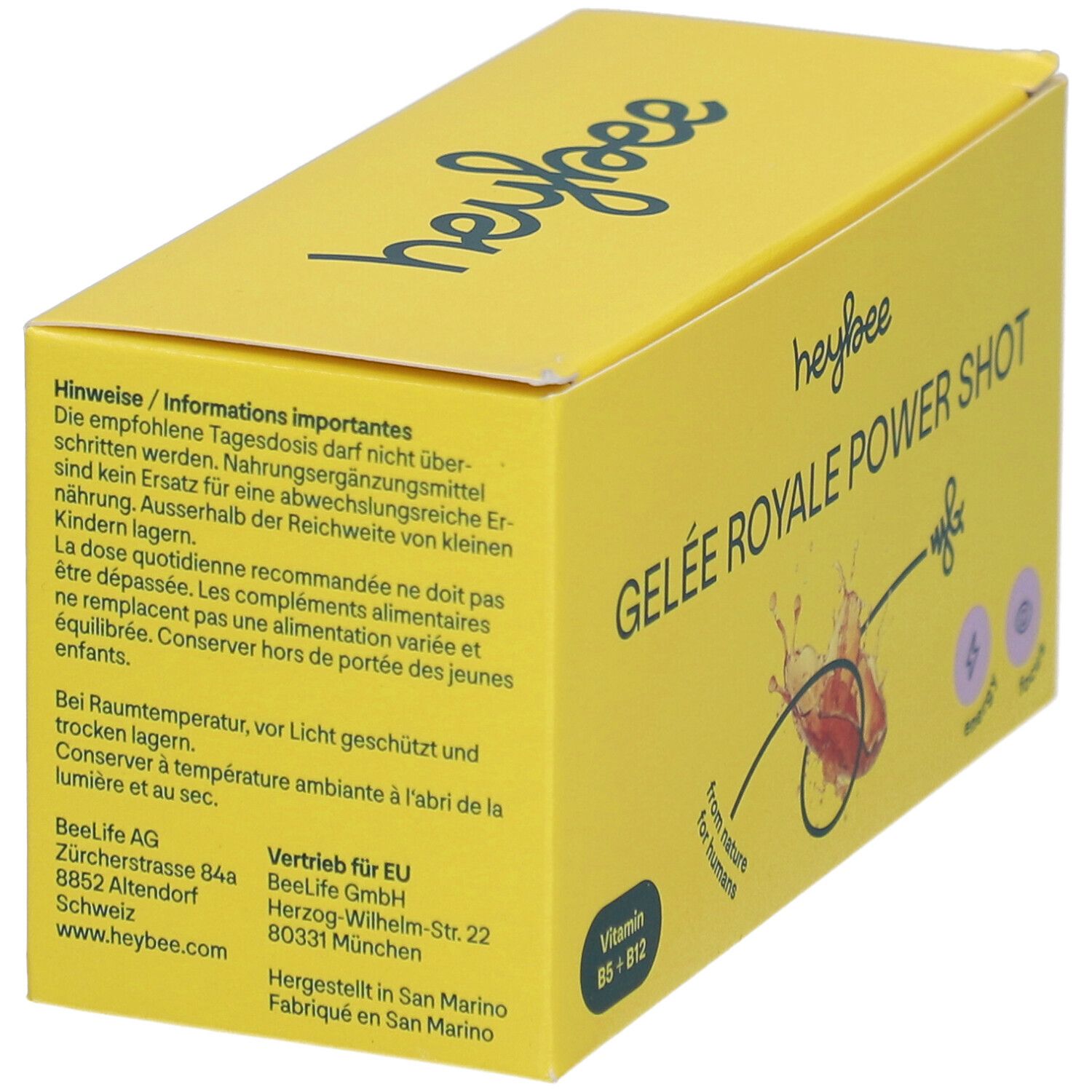 Gelbe Schachtel mit "HEYBEE Gelee Royale Power Shot". Text mit Informationen und Warnhinweisen. Logo und Produktname sind sichtbar.