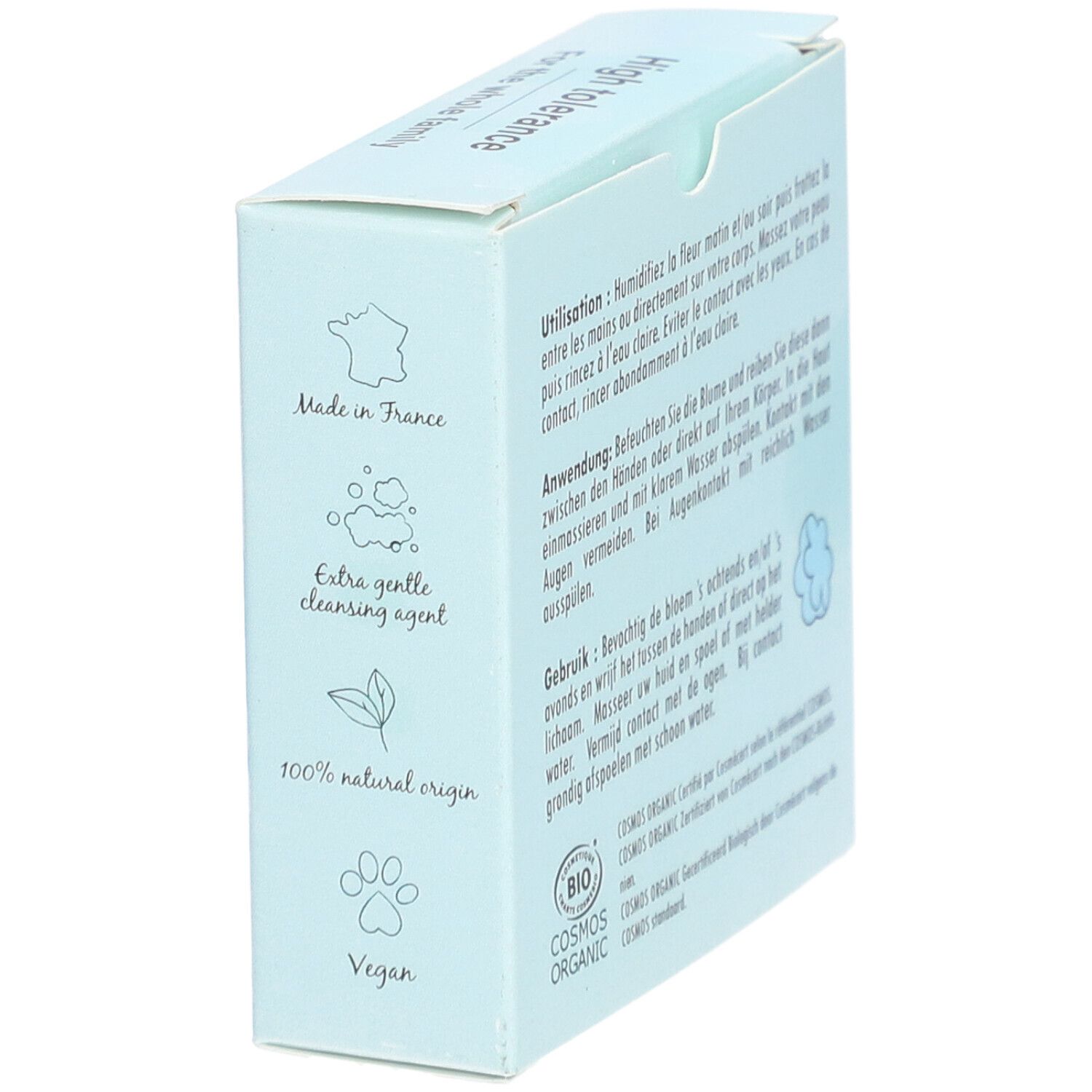Boîte bleu clair avec nom et logo du produit. Texte: PAIN LAVANT DERMATOLOGIQUE VISAGE & CORPS. Symboles: Fabriqué en France, Vegan.