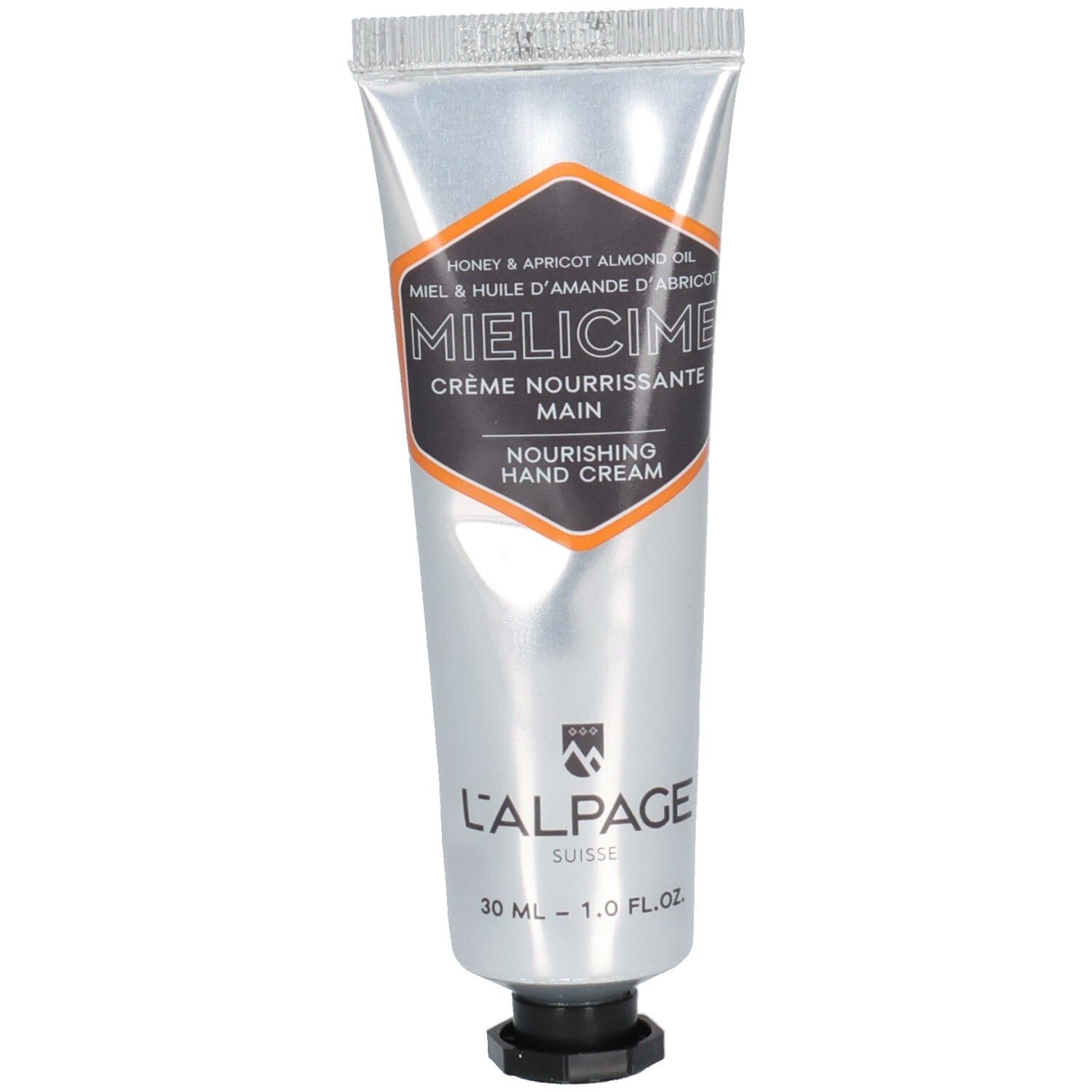 Handcreme-Tube. Silberfarben, mit schwarzem und orangefarbenem Etikett. Text: Mielicime, Crème Nourrissante Main, L'Alpage Suisse.