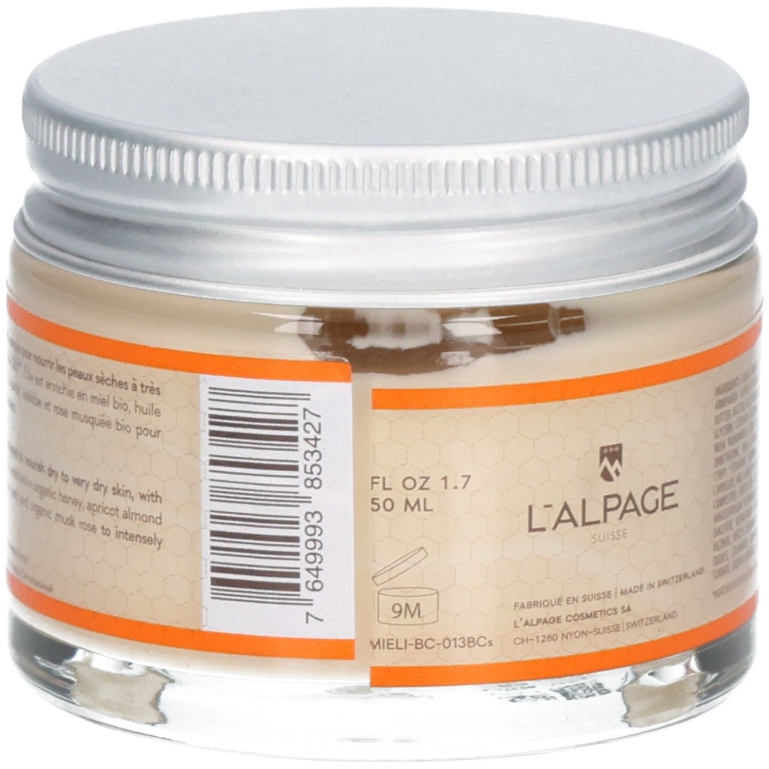 Glasbehälter mit silbernem Deckel, enthält eine helle Creme. Etikett mit Produktinformationen und Barcode.