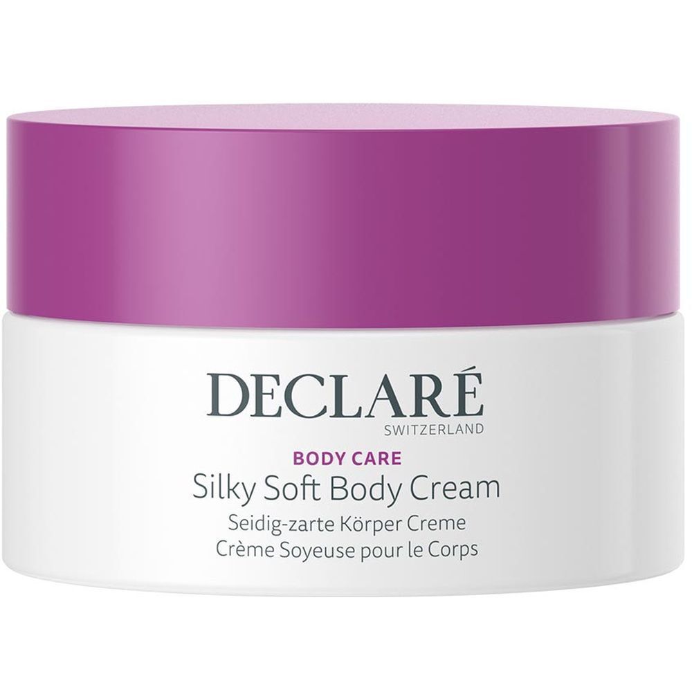 Weißer Tiegel mit lila Deckel. Aufschrift: DECLARÉ SWITZERLAND, BODY CARE, Silky Soft Body Cream. Mehrsprachige Produktbezeichnungen.