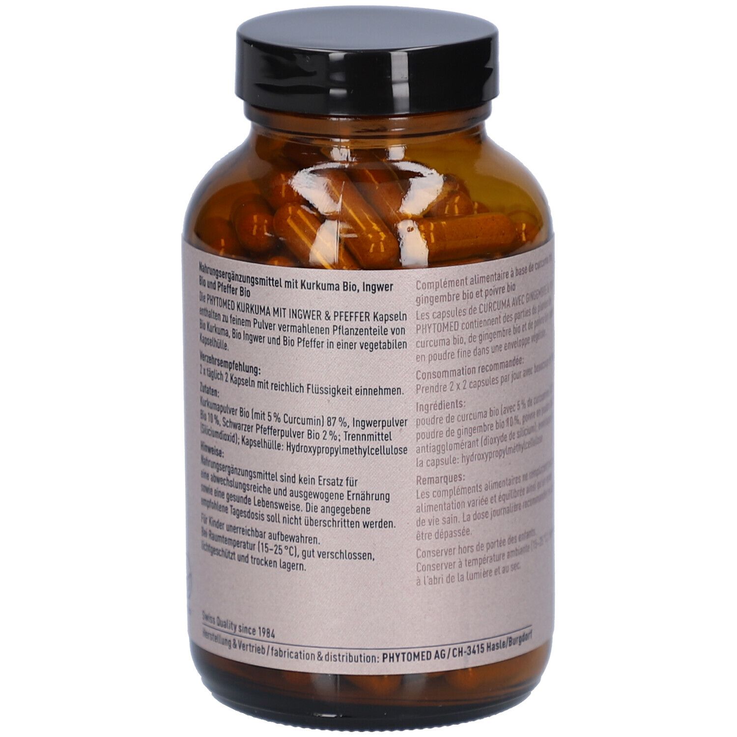 Braune Glasflasche mit schwarzen Deckel. Text auf Etikett. Kurkuma Kapseln mit Ingwer & Pfeffer Bio. Nahrungsergänzungsmittel. Inhaltsstoffe.