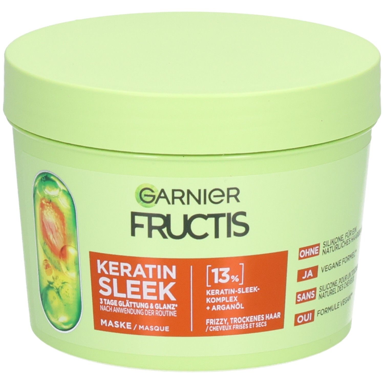 Garnier Fructis Keratin Sleek Maske in einem hellgrünen Tiegel mit orangefarbenem Etikett, zeigt eine Kapsel mit Arganöl.