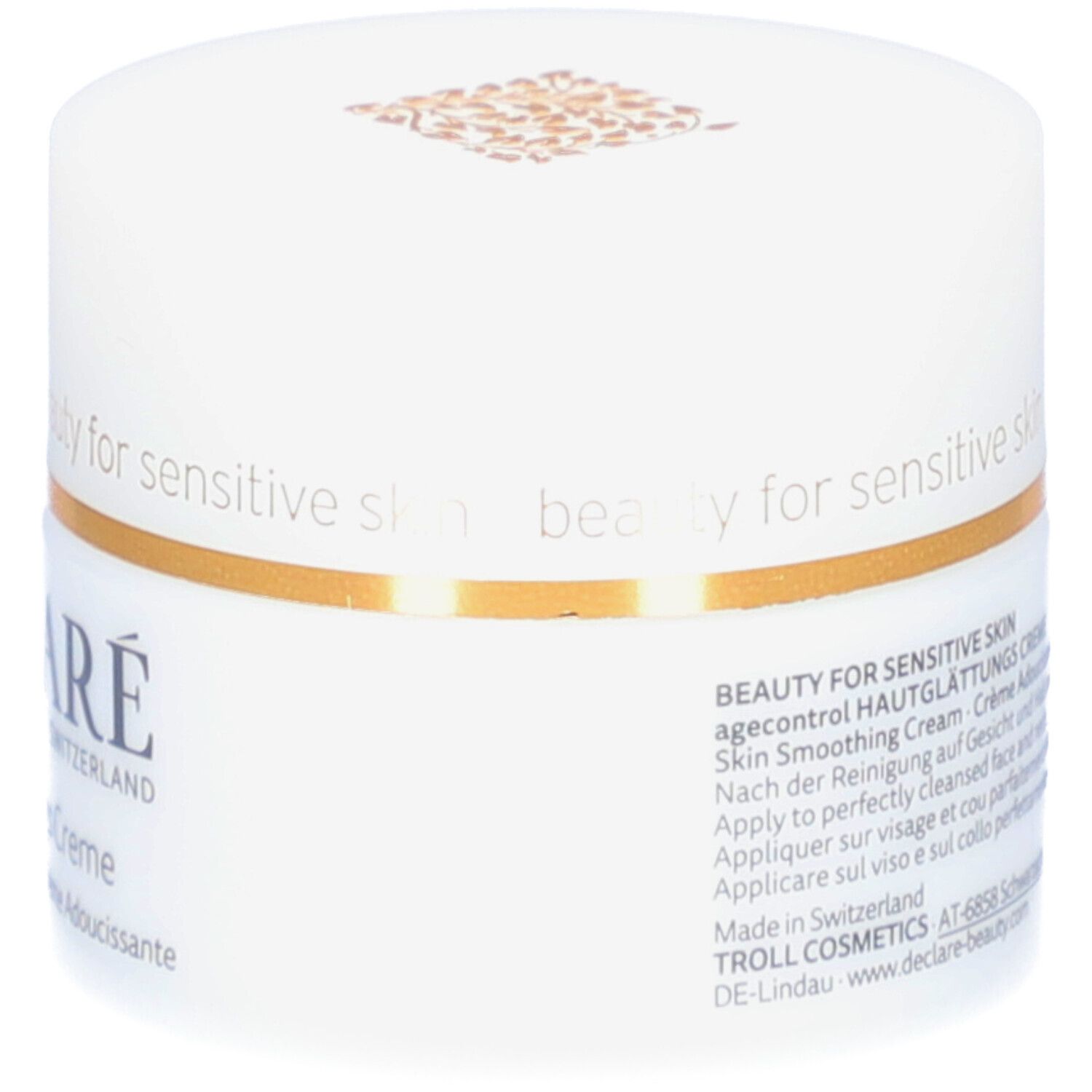 Weißer Tiegel mit Deckel. Goldener Zierstreifen. DECLARÉ-Logo und Produktbezeichnung. Aufschrift: Hautglättungs Creme. 50 ml.