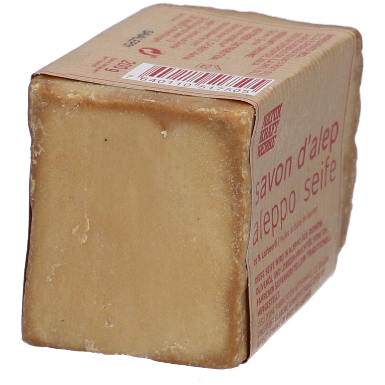 Rechteckige Seife mit Papierbanderole. Aufschrift: savon d'alep aleppo seife. Barcode und Natur Kraft Werke Logo.