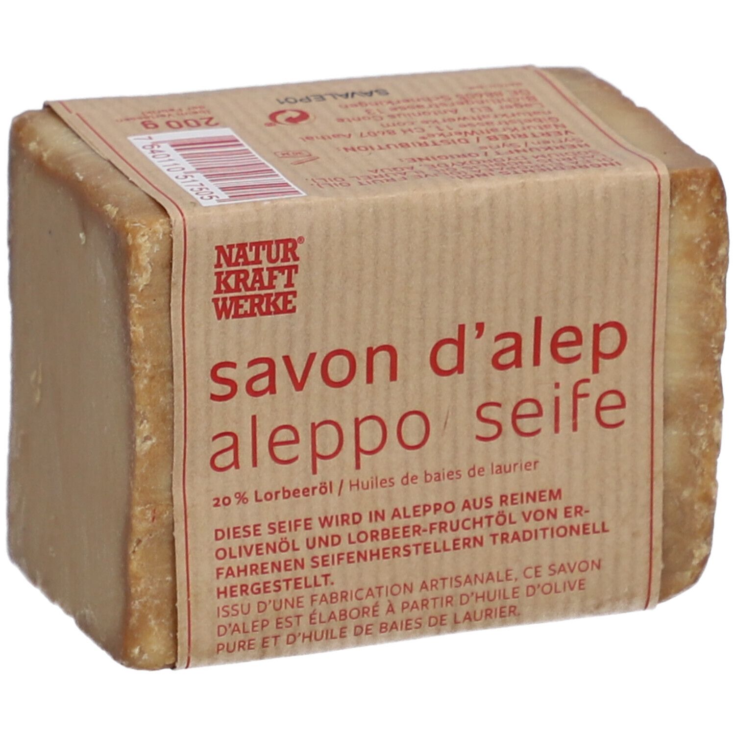 Rechteckige Seife mit Papierbanderole. Aufschrift: savon d'alep aleppo seife, 20% Lorbeeröl. Natur Kraft Werke.