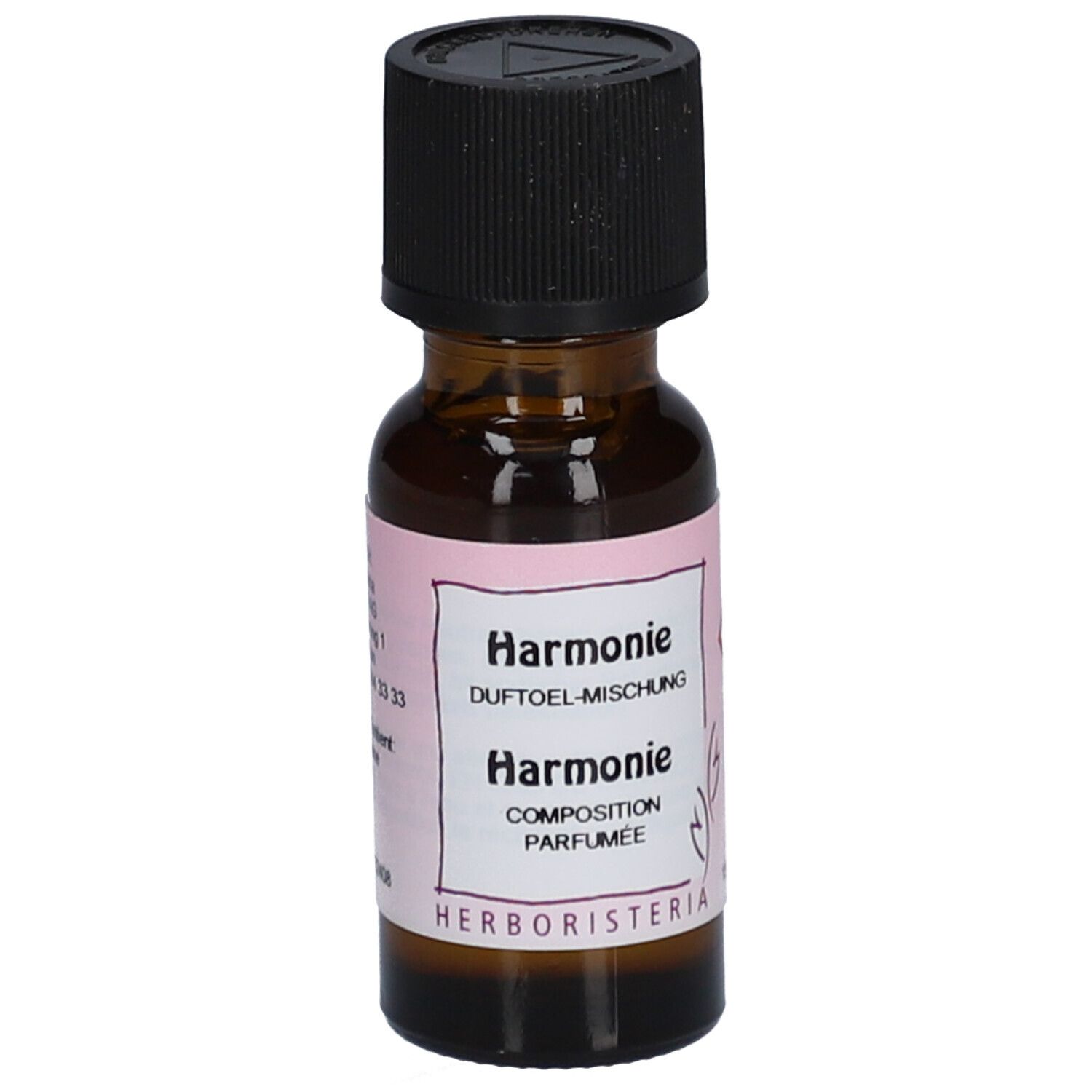 Flacon en verre brun avec bouchon noir. Étiquette rose avec texte: Harmonie, Duftöl-Mischung, HERBORISTERIA.