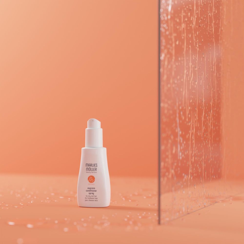 Weiße Flasche vor orangefarbenem Hintergrund. Aufschrift: Marlies Möller, softness, Express Conditioner Spray.