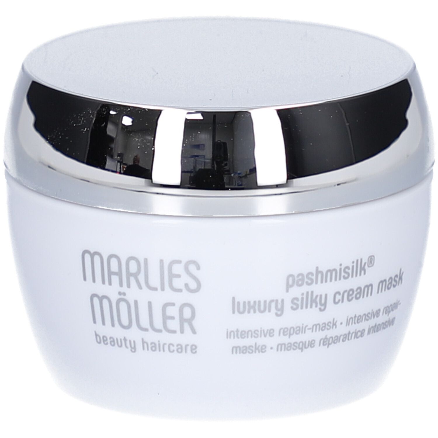 Weiße Dose mit silbernem Deckel. Aufschrift: Marlies Möller, pashmisilk luxury silky cream mask. Mehrsprachige Texte.