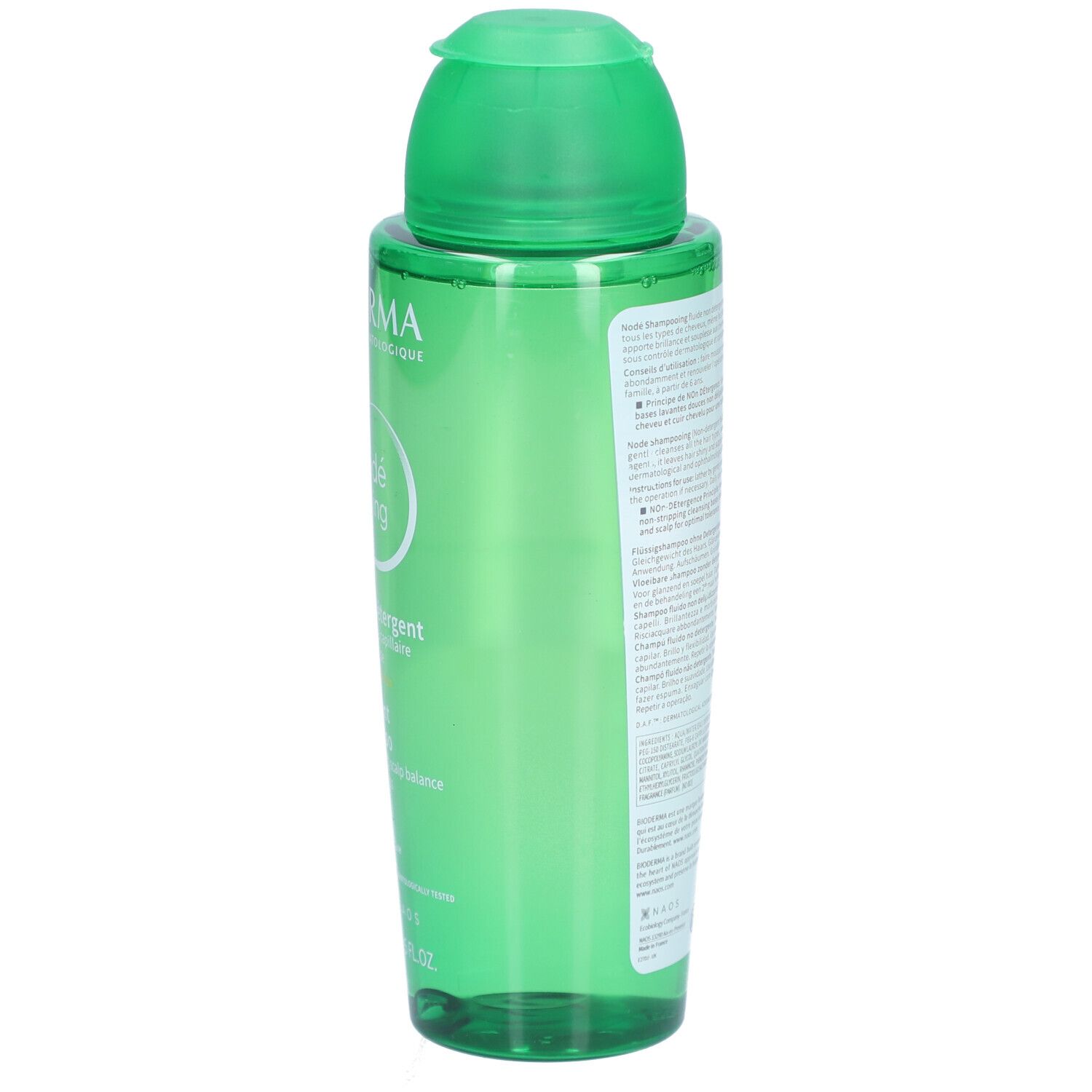 Seite der grünen Shampoo-Flasche. Text auf dem Etikett. Klappverschluss oben.