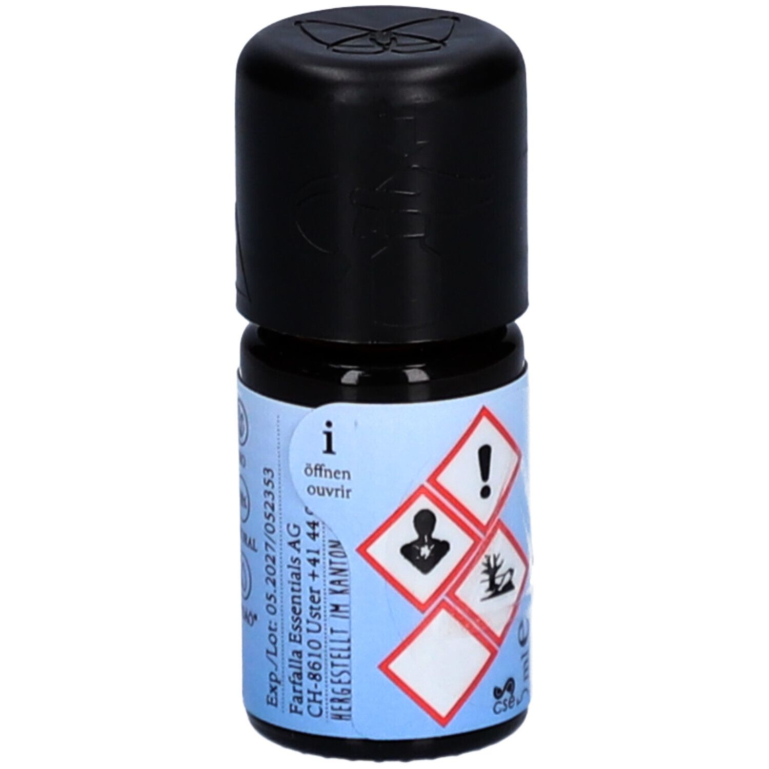 Petite bouteille en verre avec bouchon noir. Étiquette avec symboles de danger, instructions d'ouverture et informations du fabricant.