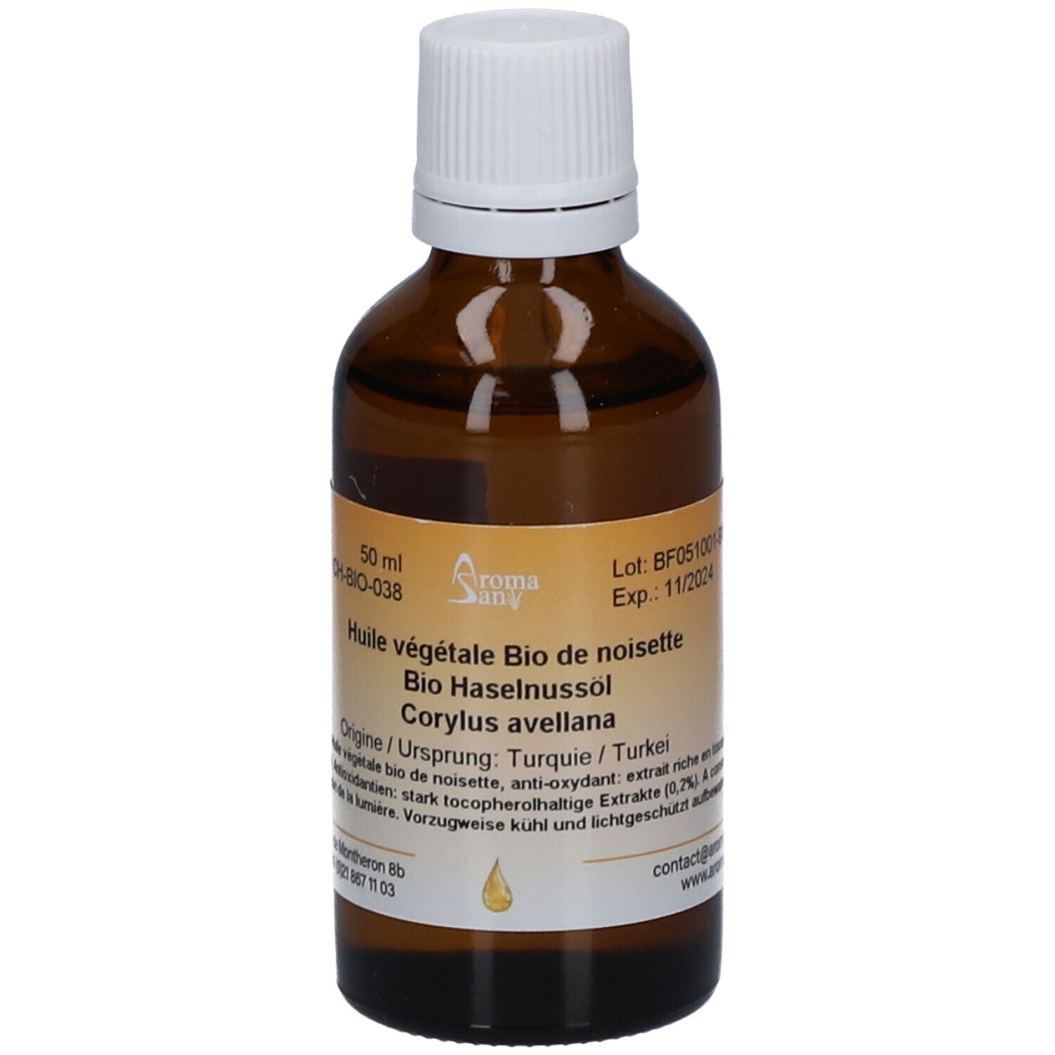Bruine glazen fles met witte dop. Etiket met productnaam, ingrediënten en batchnummer. Druppelsymbool.