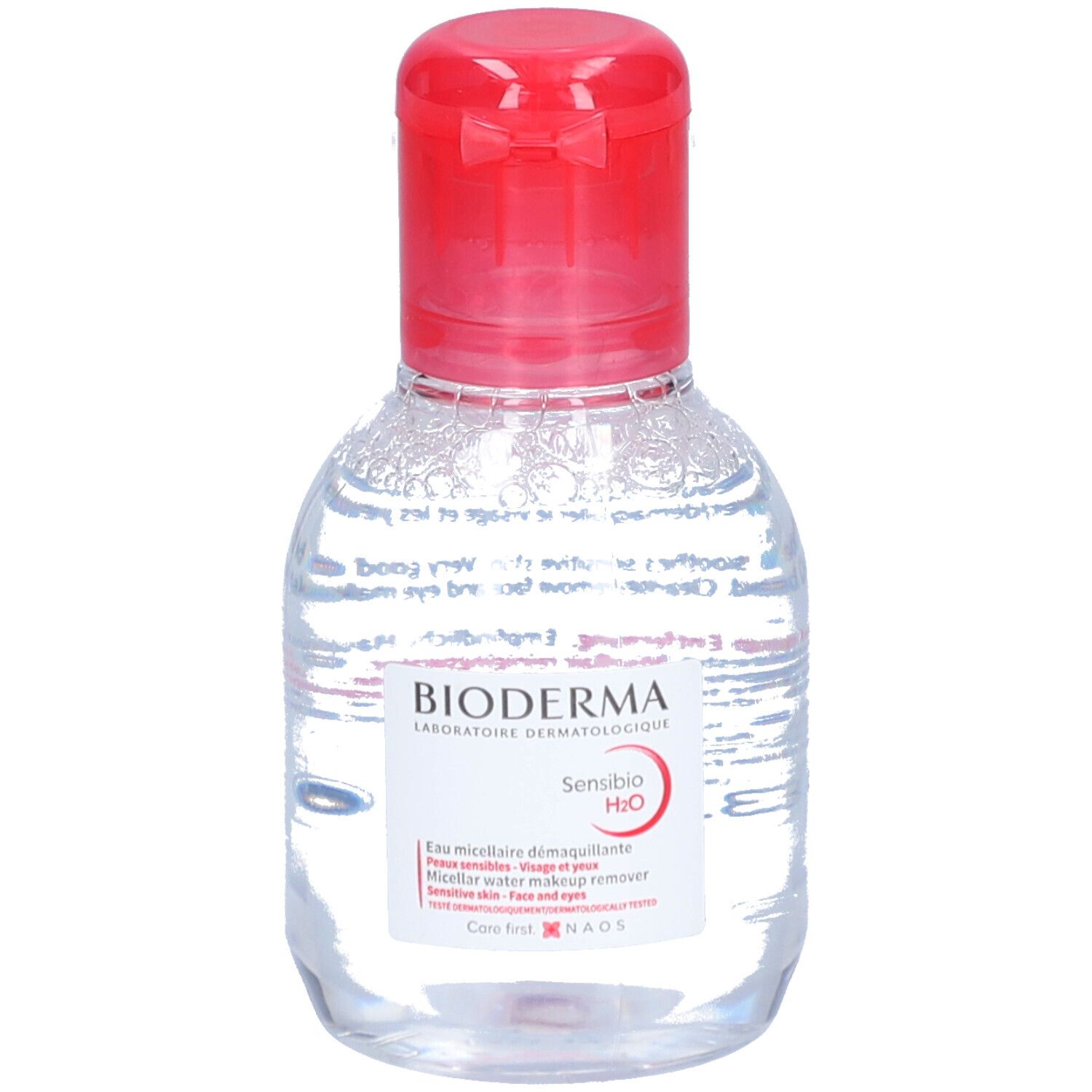 Flacon transparent, bouchon rouge. Étiquette BIODERMA Sensibio H2O. Eau micellaire démaquillante.