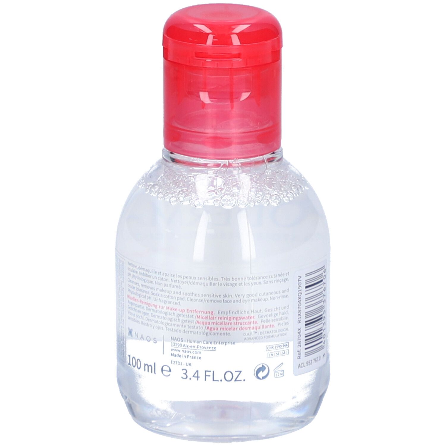 Flacon transparent, bouchon rouge. Étiquette avec texte et 100 ml. Eau micellaire démaquillante.