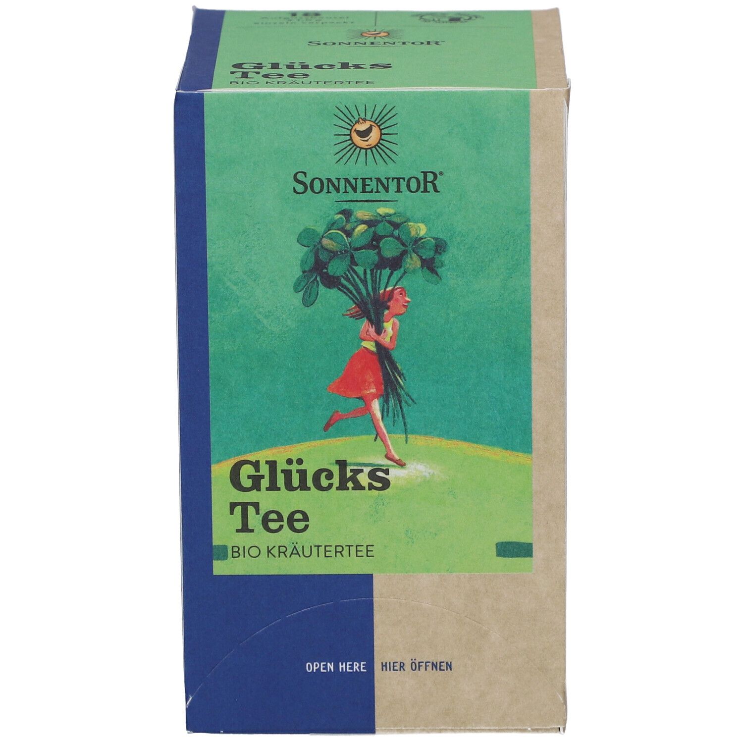 Karton mit Glücks Tee. Vorderseite mit Mädchen, Kleeblättern, Sonnenlogo, Text. Grün, Blau, Beige.