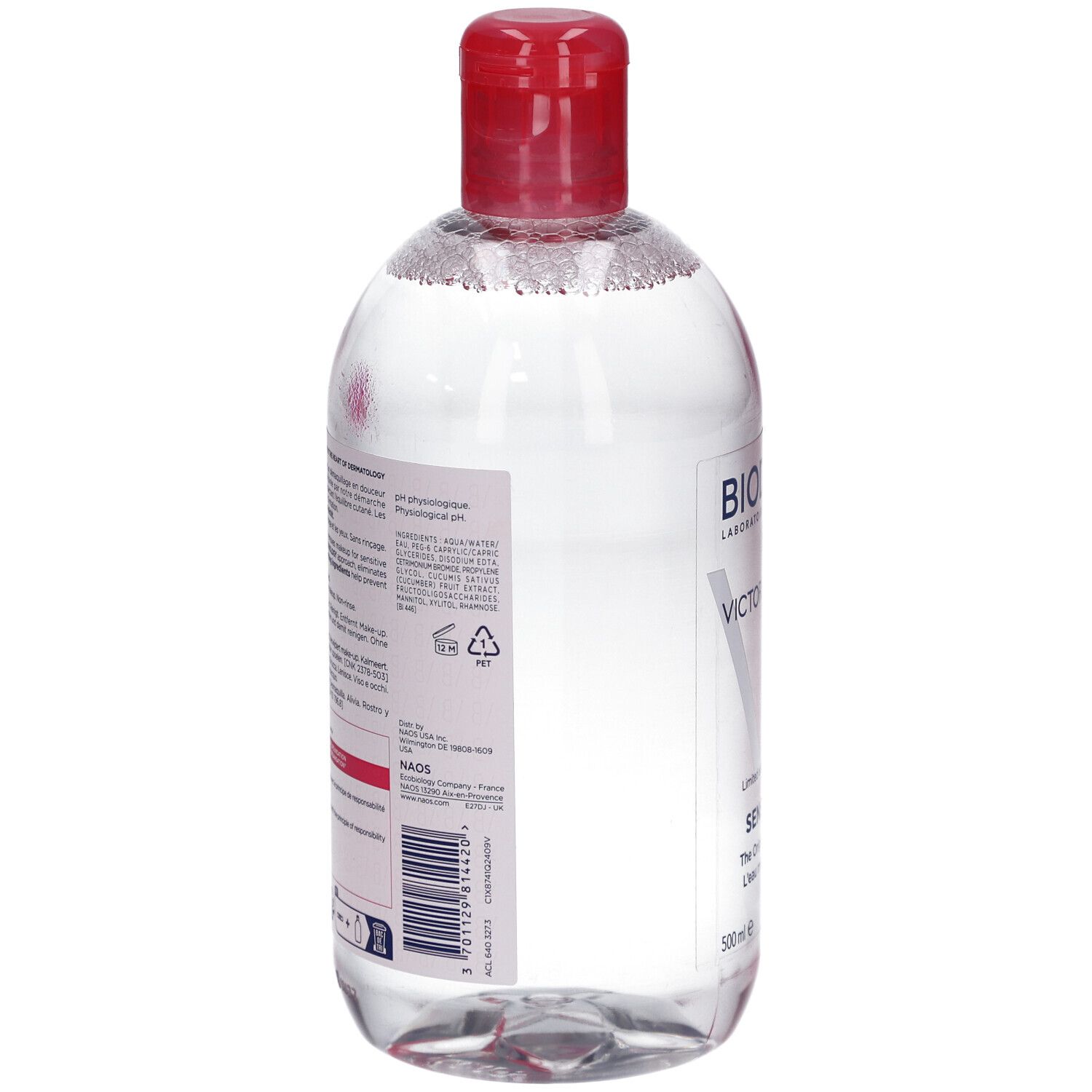 Rückseite der Flasche. Etikett mit Inhaltsstoffen und Informationen. Roter Deckel. Transparente Flüssigkeit.