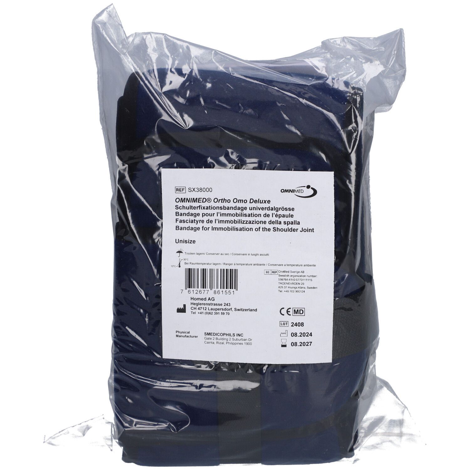 Blaues Omnimed Ortho Omo Deluxe Schulterfixationsbandage in Plastikverpackung. Produktetikett mit Text und CE-Kennzeichnung.