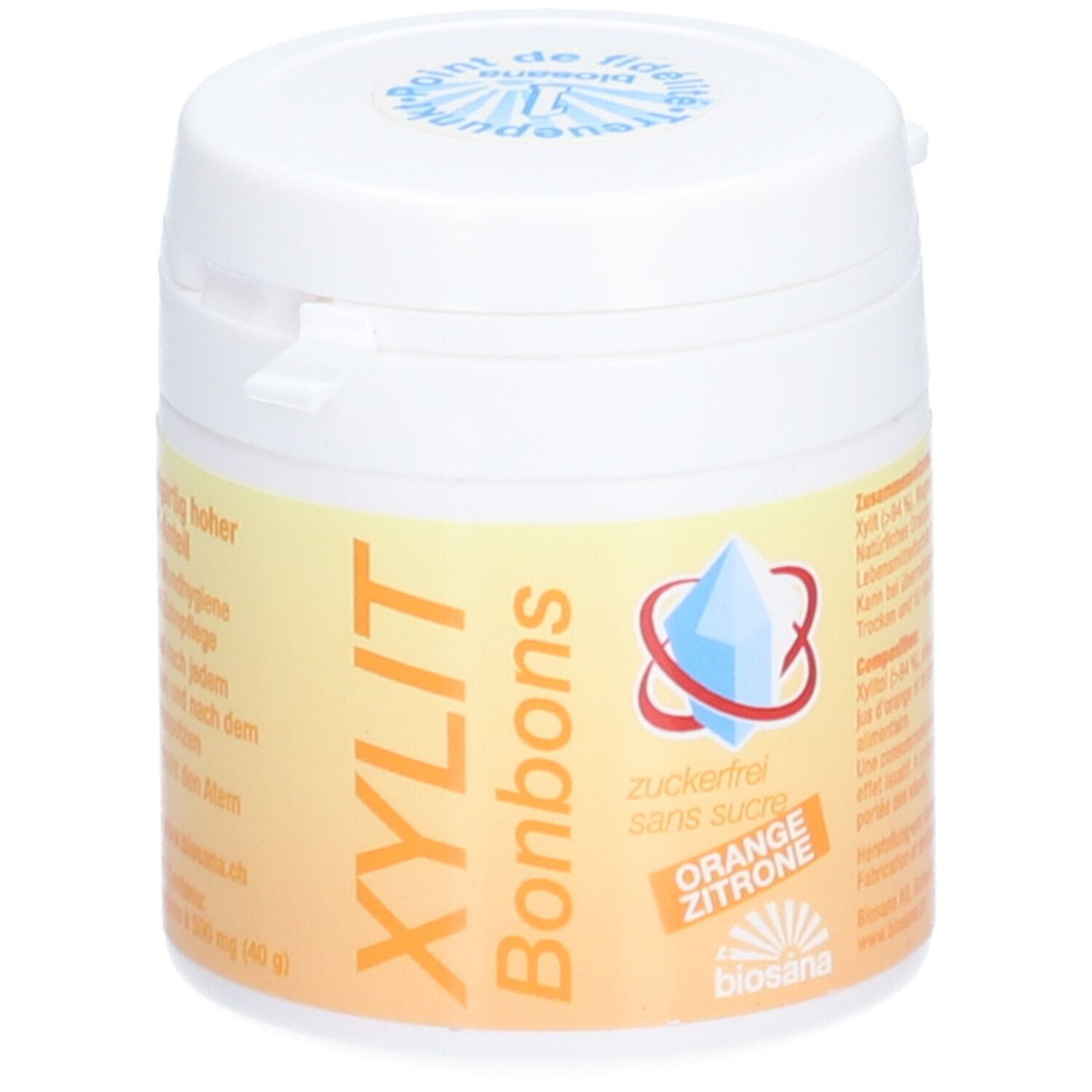 Witte pot met deksel. Opschrift: XYLIT Bonbons, suikervrij, Sinaasappel Citroen. Logo met blauw kristal.
