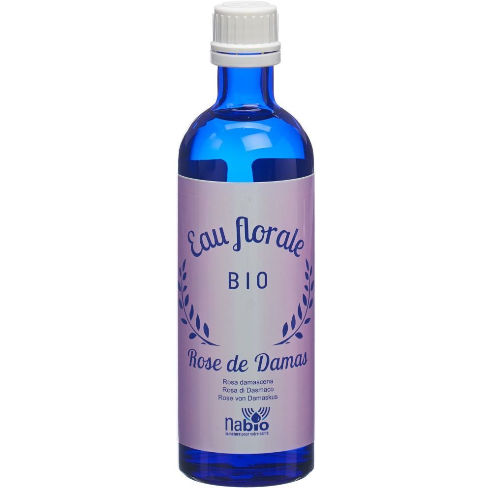 Blaue Glasflasche mit weißem Deckel. Etikett mit "Eau florale BIO Rose de Damas".