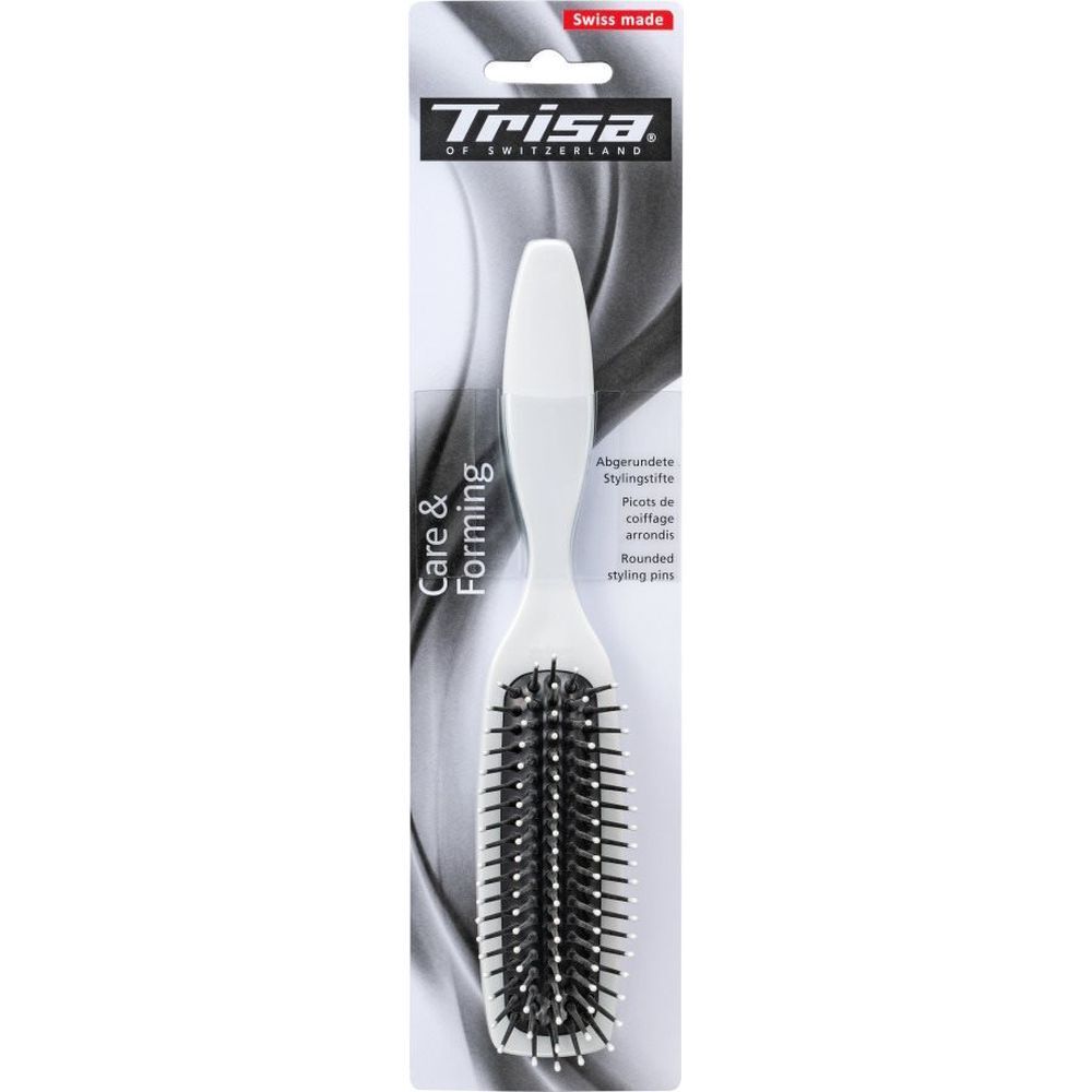 Weiße Haarbürste mit schwarzem Borstenfeld. Auf der Verpackung steht "Trisa" und "Swiss made".