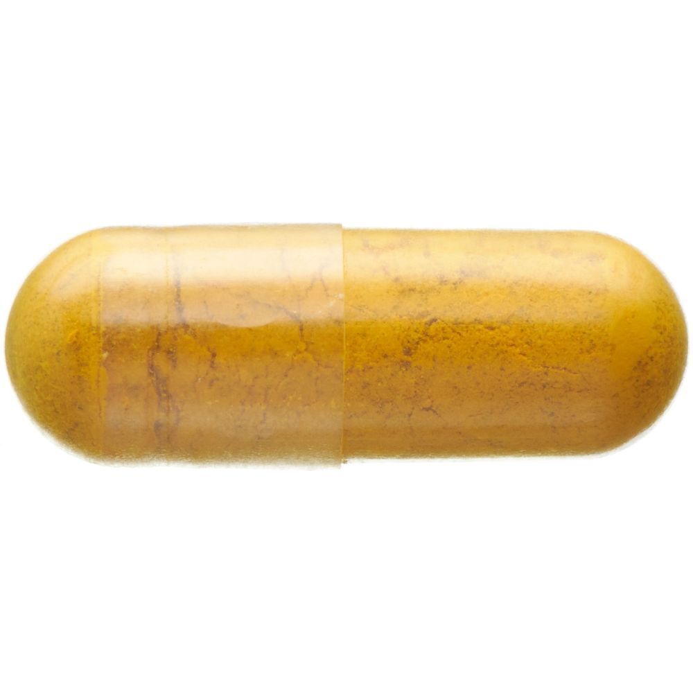 Einzelne gelbe Kapsel. Kapsel mit gelber Farbe. Enthält Kurkuma, Grüntee-Extrakt und Vitamin C.
