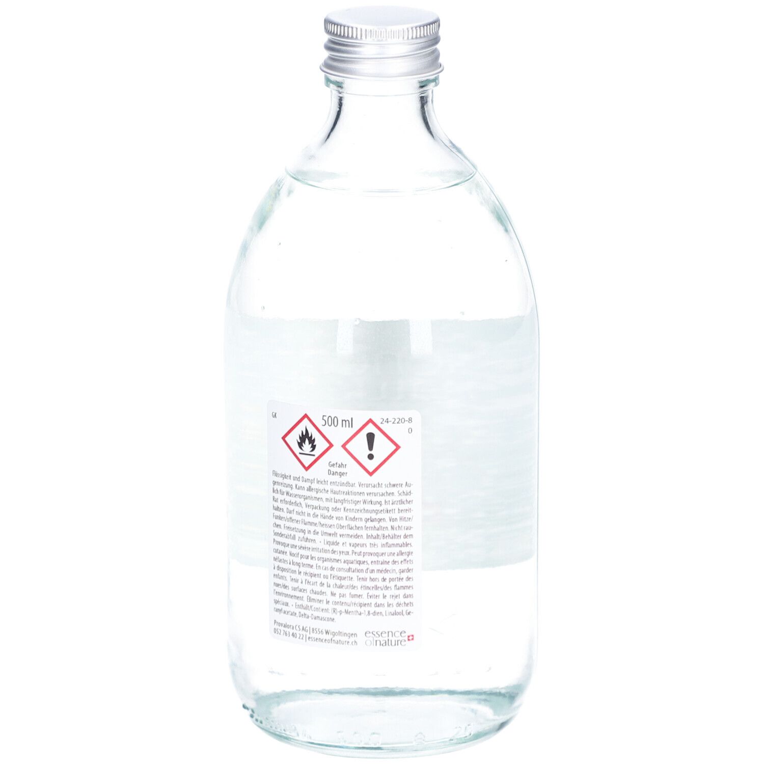 Glasflasche mit silbernem Deckel. Rückseite mit Etikett und Warnhinweisen. 500 ml.