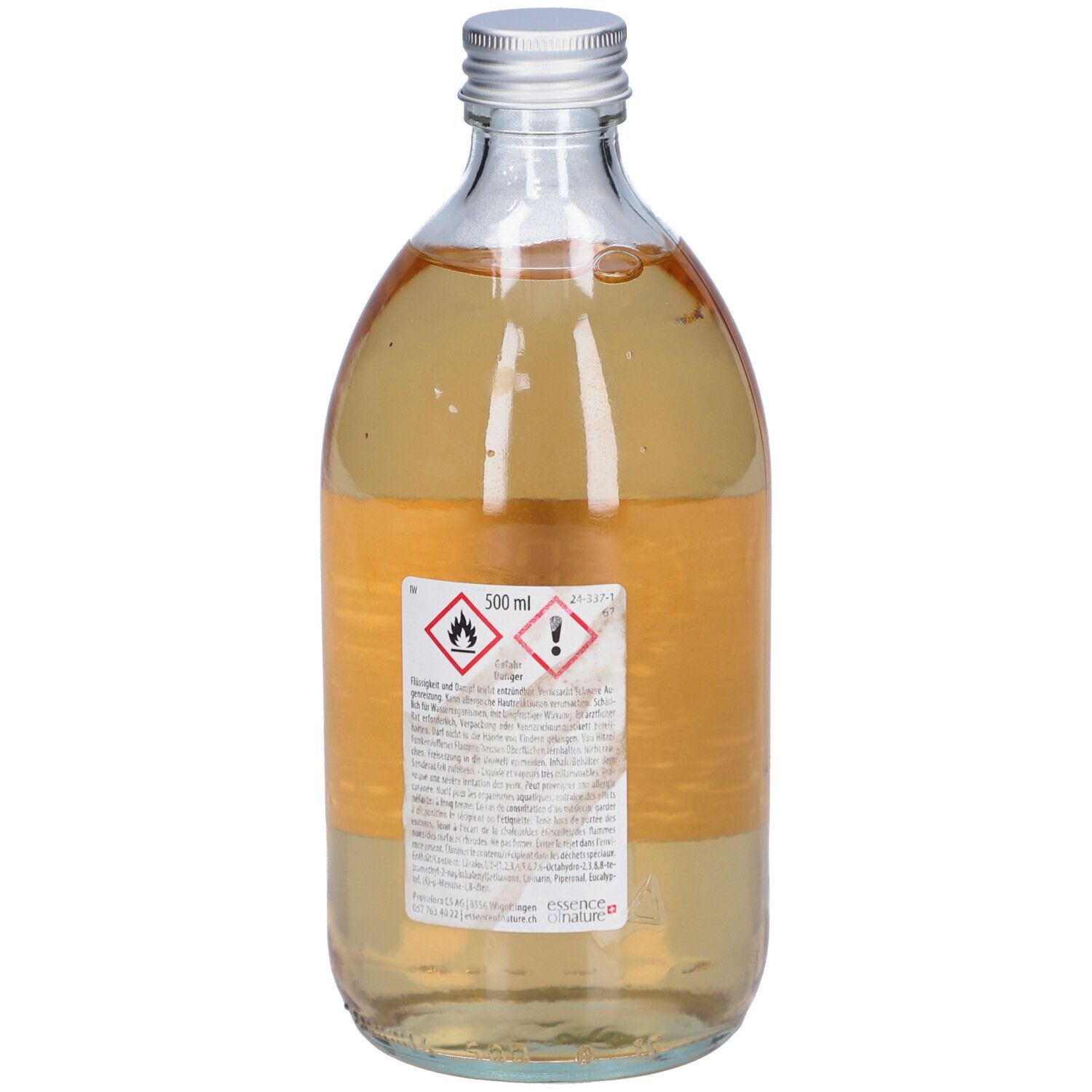Glasflasche mit silbernem Deckel. Rückseite mit Etikett und Warnhinweisen. Flüssigkeit.