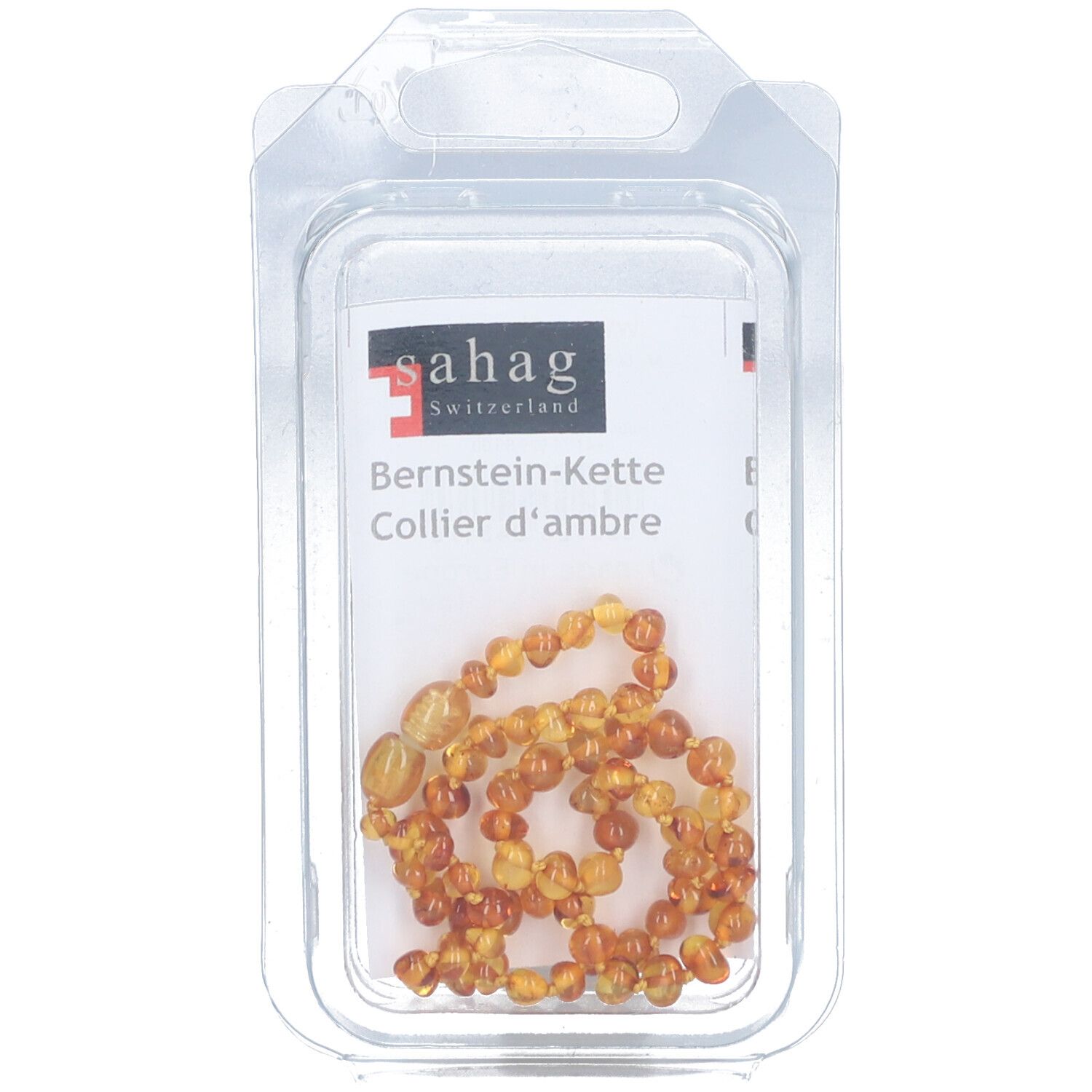 Collier d'ambre Sahag en blister. Perles ambrées. Texte: Bernstein-Kette, Collier d'ambre. Logo Sahag.