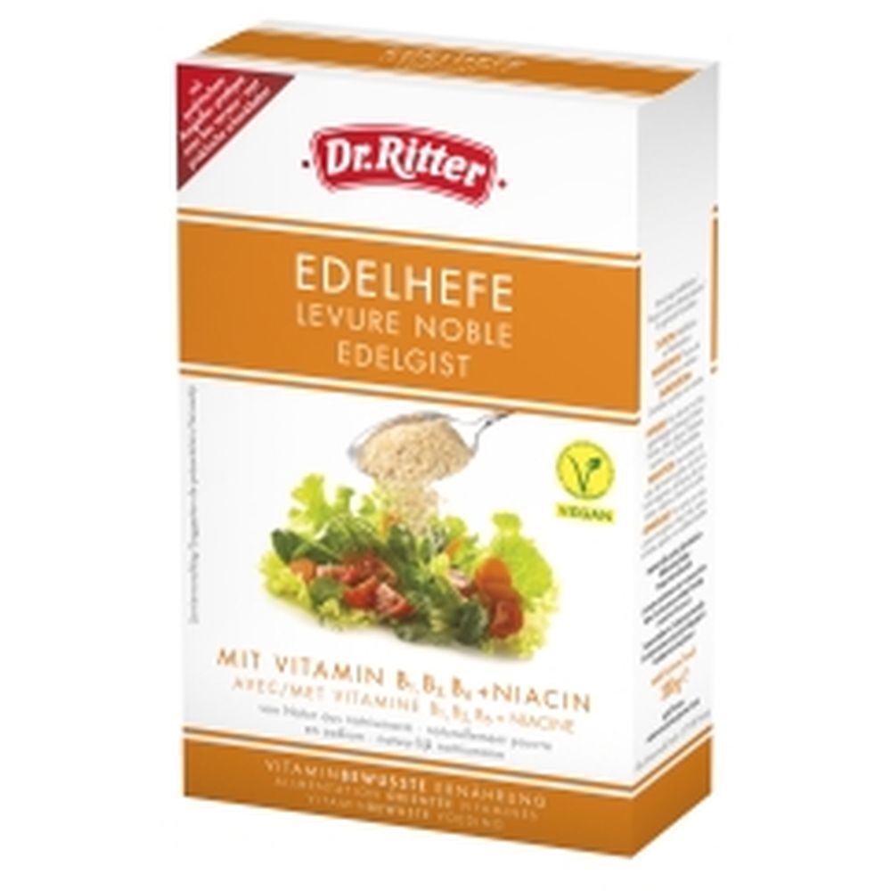 Verpackung von Dr. Ritter Edelhefe Flocken. Aufdruck: Edelhefe, Vegan-Siegel, Vitamin B-Komplex. Abbildung: Salat mit Flocken.