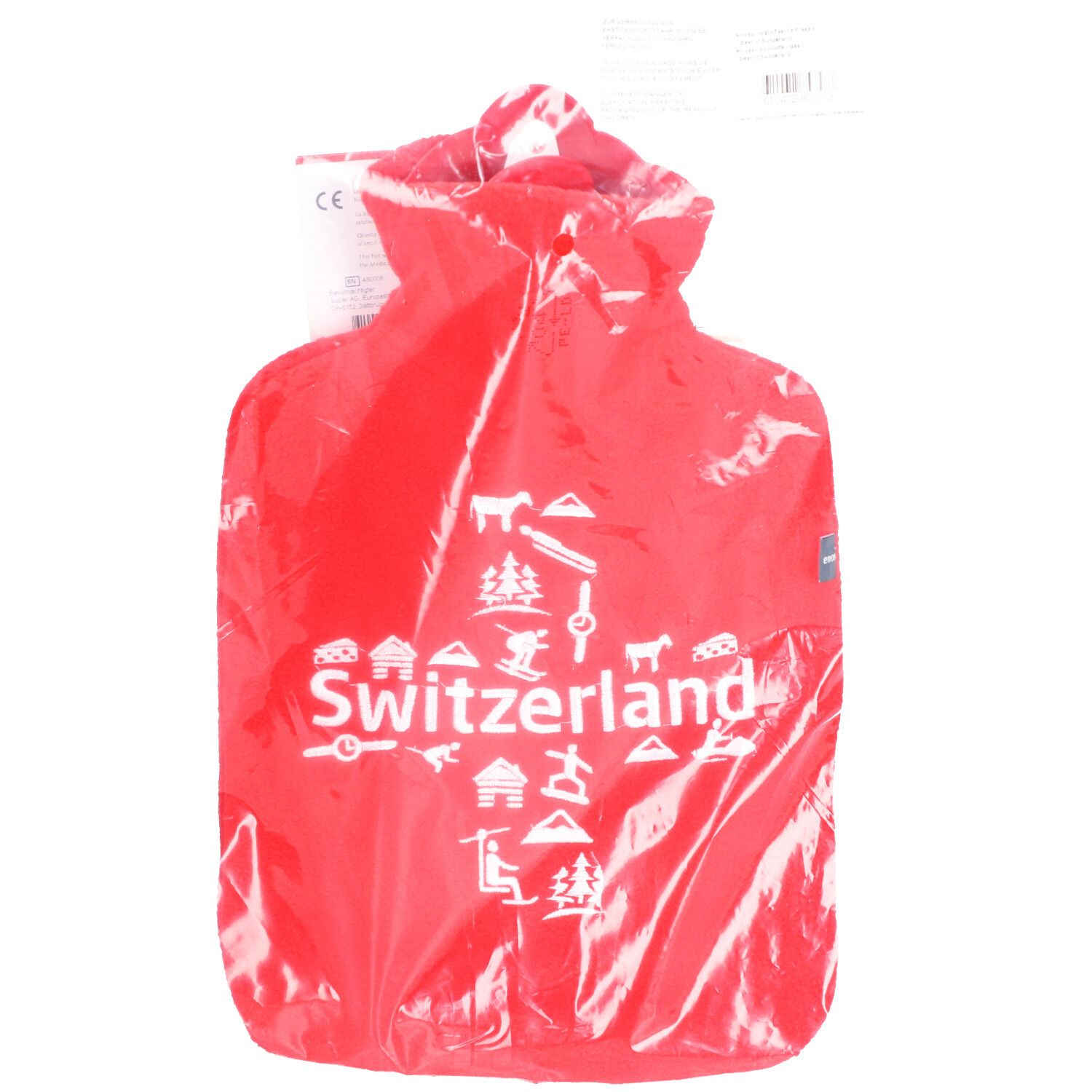 Bouillotte rouge emballée. Inscription "Switzerland" avec symboles. Marquage CE visible.