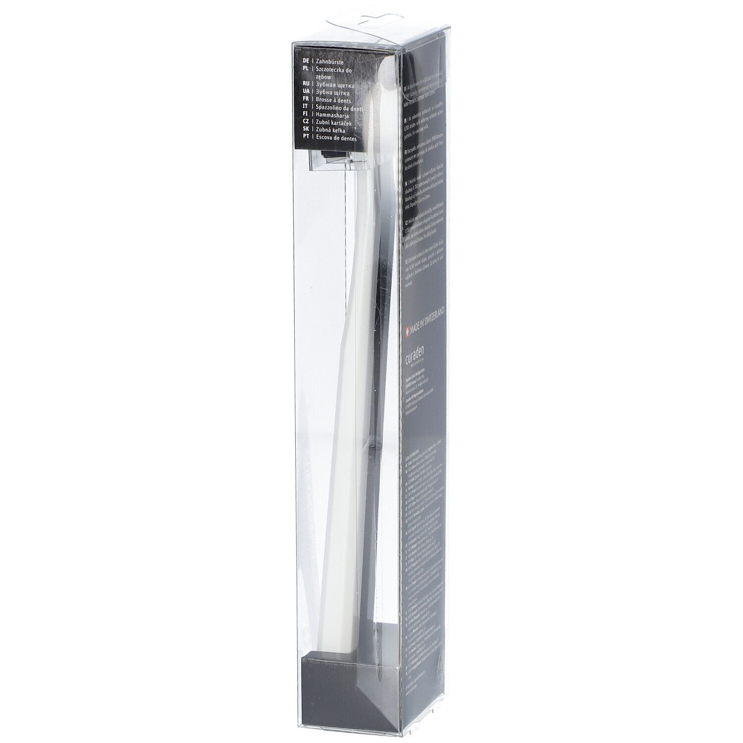 Zahnbürste in Verpackung. Weiße Zahnbürste, schwarzer Griff. Transparente Kunststoffverpackung.