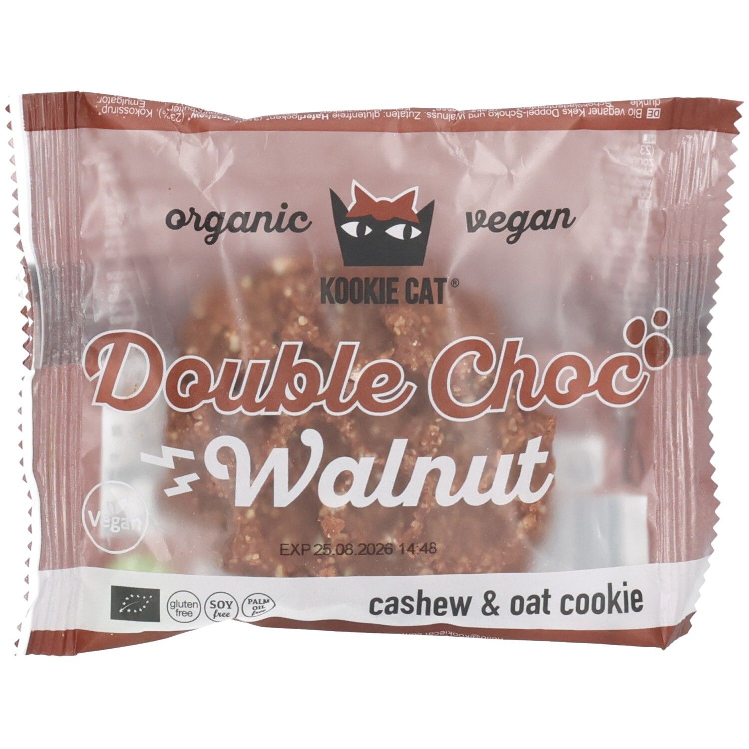 Verpackte Kookie Cat Cookie. Aufschrift: Double Choc Walnut, vegan, organic. Sichtbar: Cashew & Oat Cookie, Logo, Haltbarkeitsdatum.