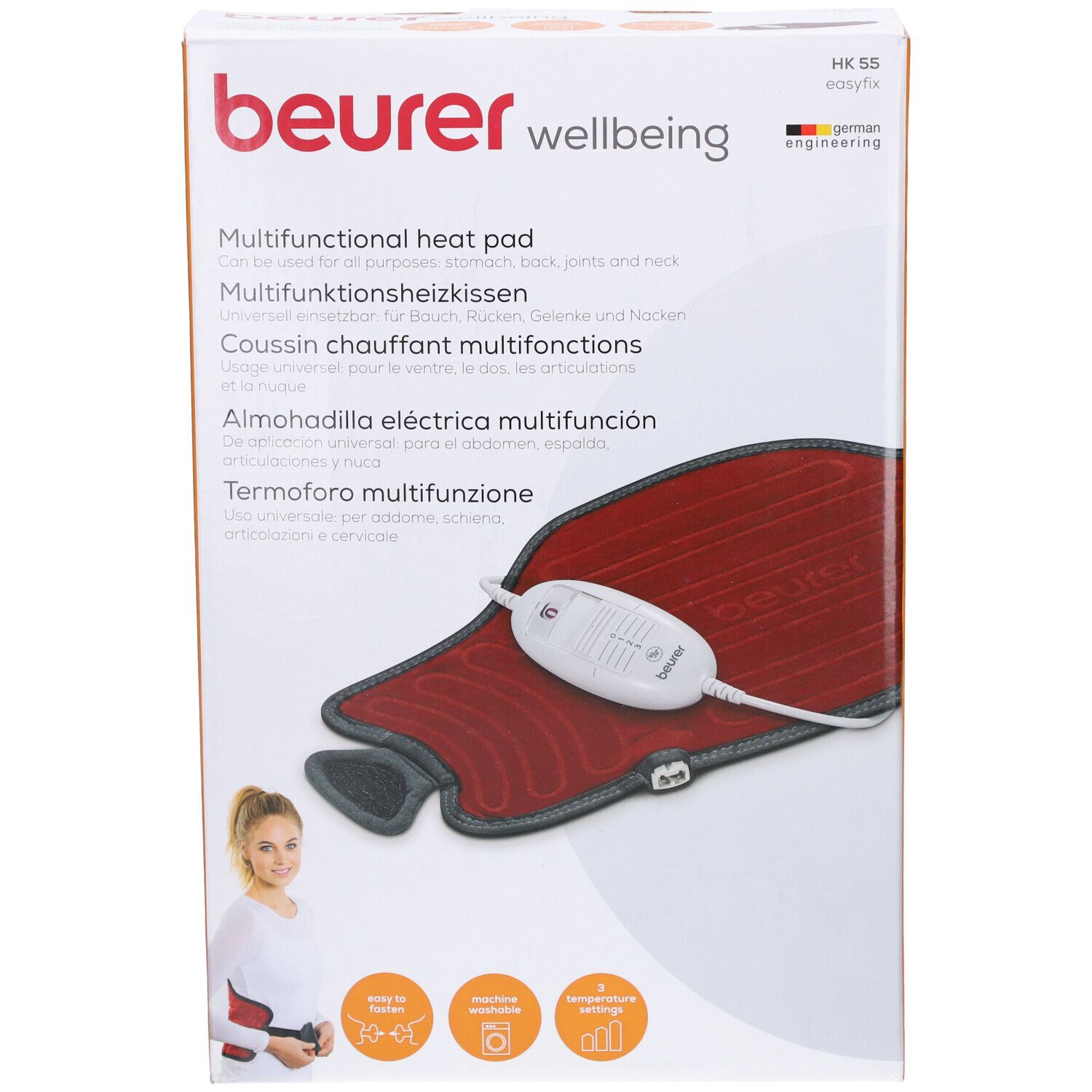 Verpackung mit Heizkissen. Rotes Kissen, grauer Rand, weißes Bedienelement. Marke: beurer.