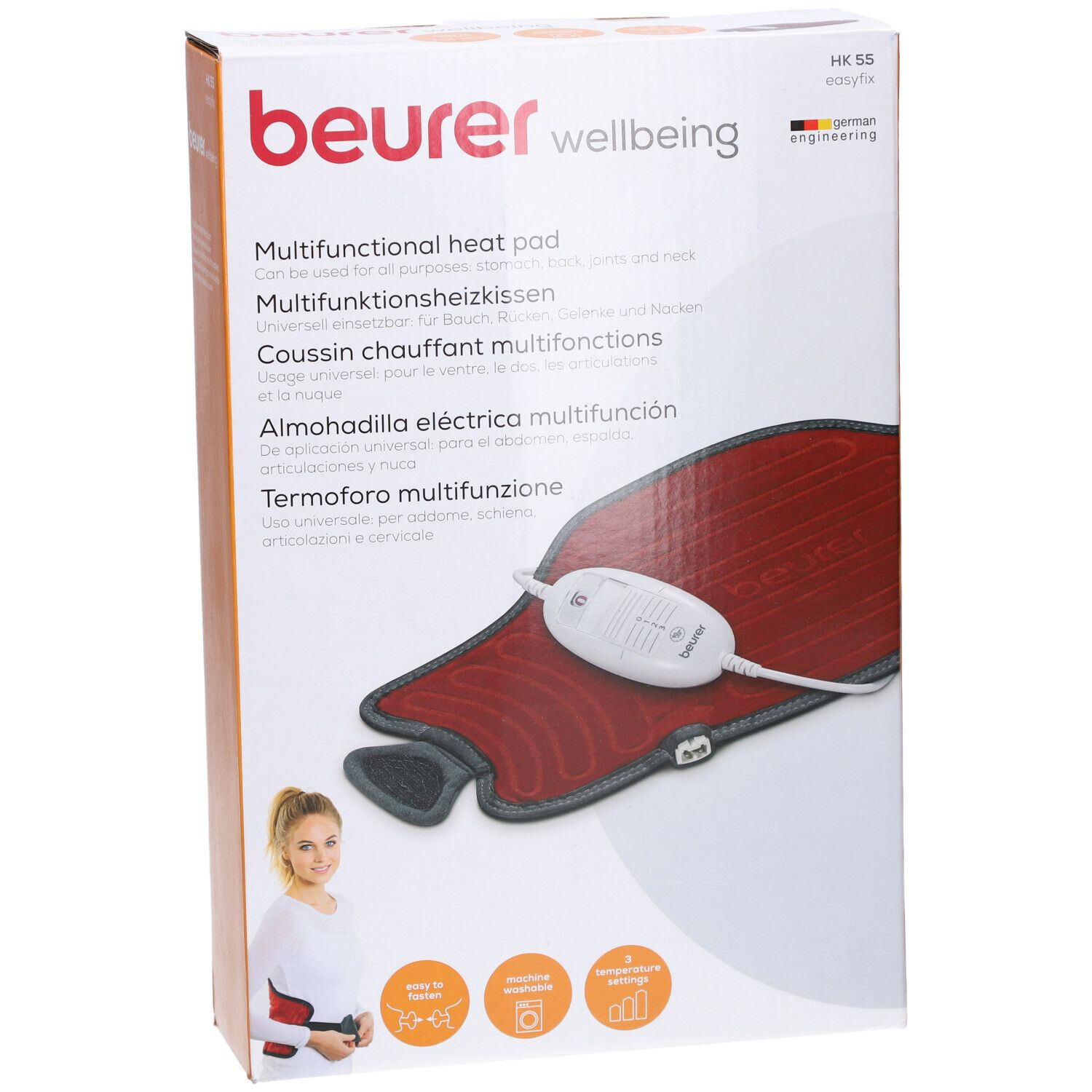 Verpackung mit Heizkissen. Rotes Kissen, grauer Rand, weißes Bedienelement. Marke: beurer.