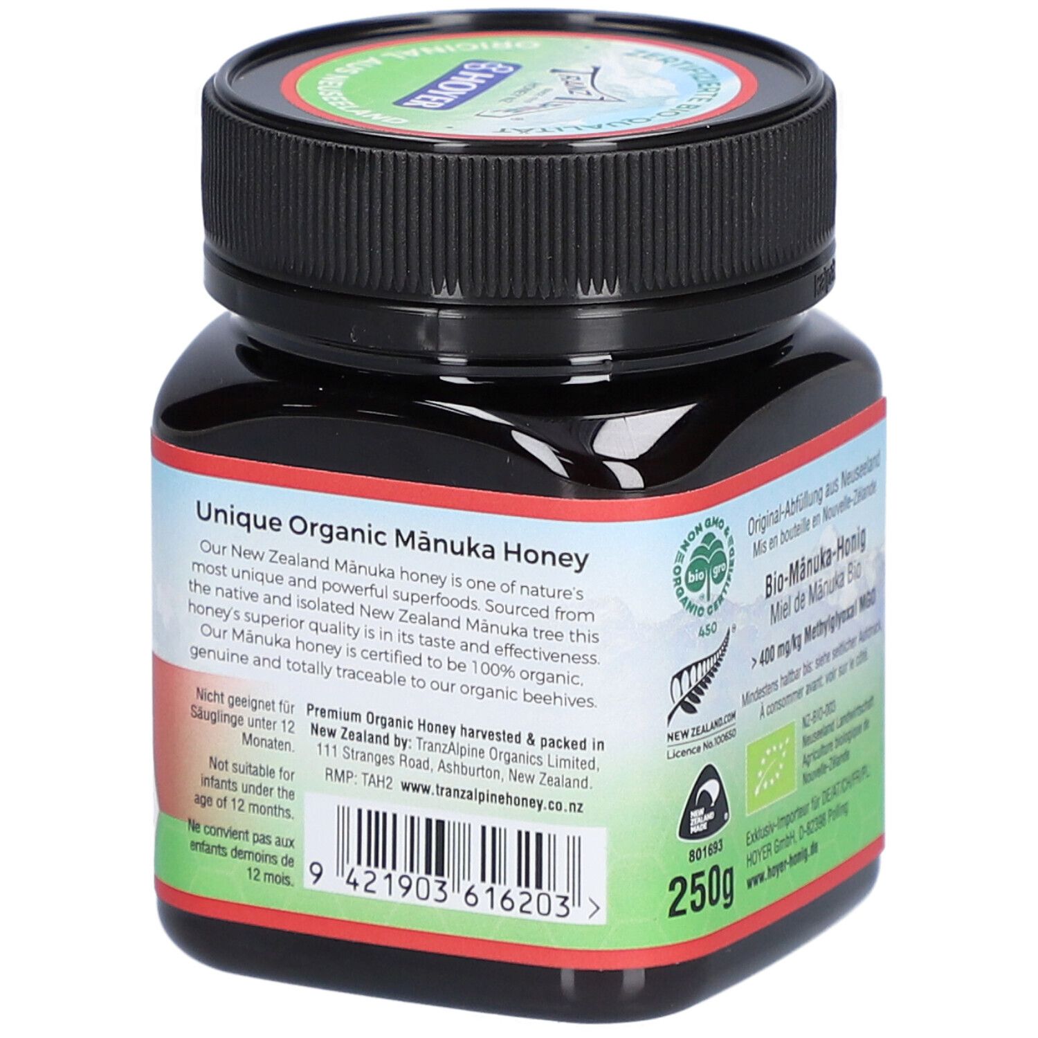 Pot en verre brun avec couvercle noir. Étiquette avec texte : Unique Organic Manuka Honey, 250g.