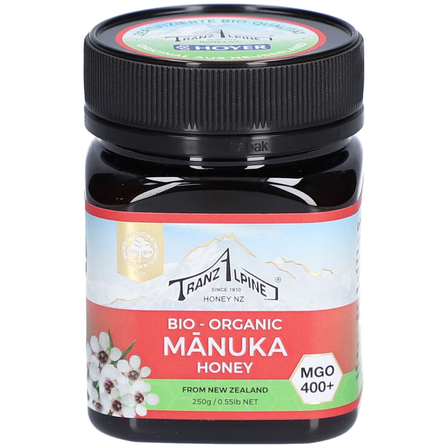 Pot en verre brun avec couvercle noir. Étiquette avec texte : Bio-Organic Manuka Honey, MGO 400+.